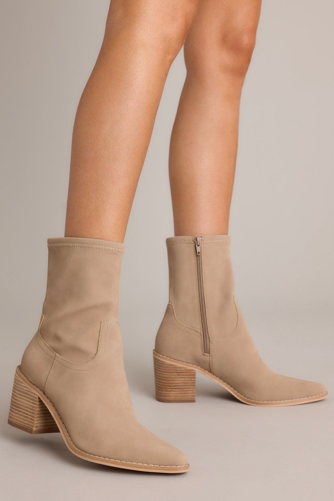 These brown boots feature a pointed toe, a platform heel, a discrete side zipper and a tan sole.