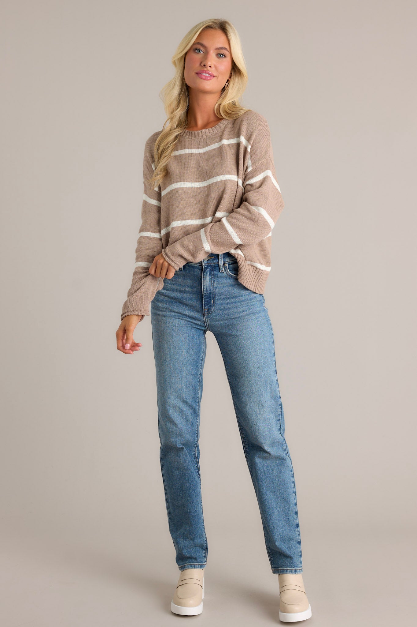 Latte tan stripe sweater with long dolman sleeves and a round neckline.