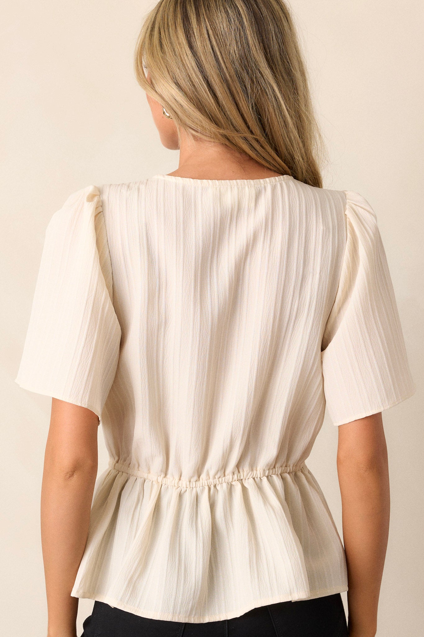 Back view of the ivory lace top highlighting the clean back design with an elastic waist insert.