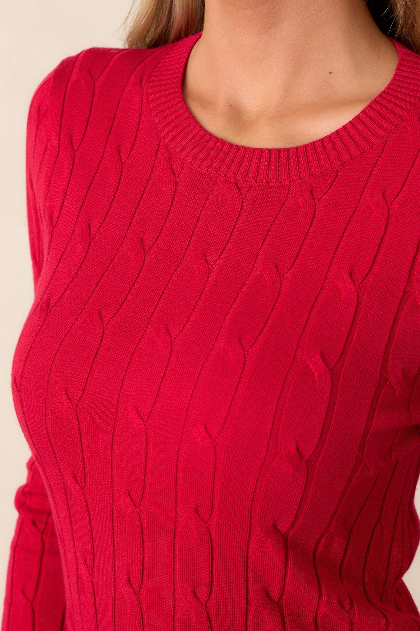 Close-up of the top focusing on the intricate cable knit design, the ribbed texture of the wrists, and the ribbed neckline