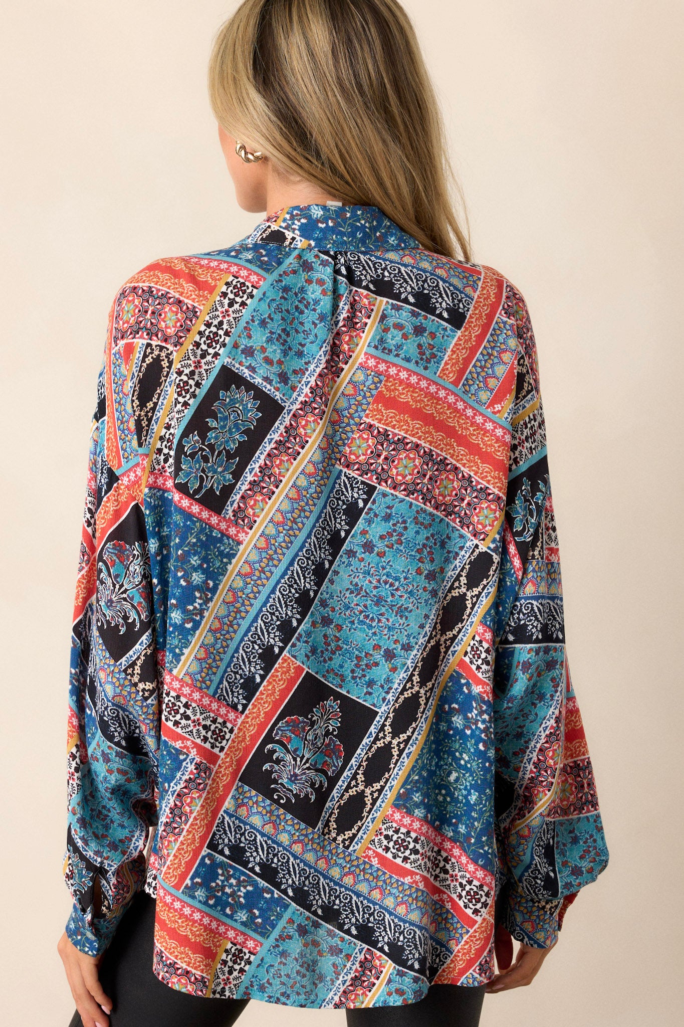 The back view of the patchwork top, showcasing the relaxed fit and overall design, emphasizing the playful elements of the fabric.