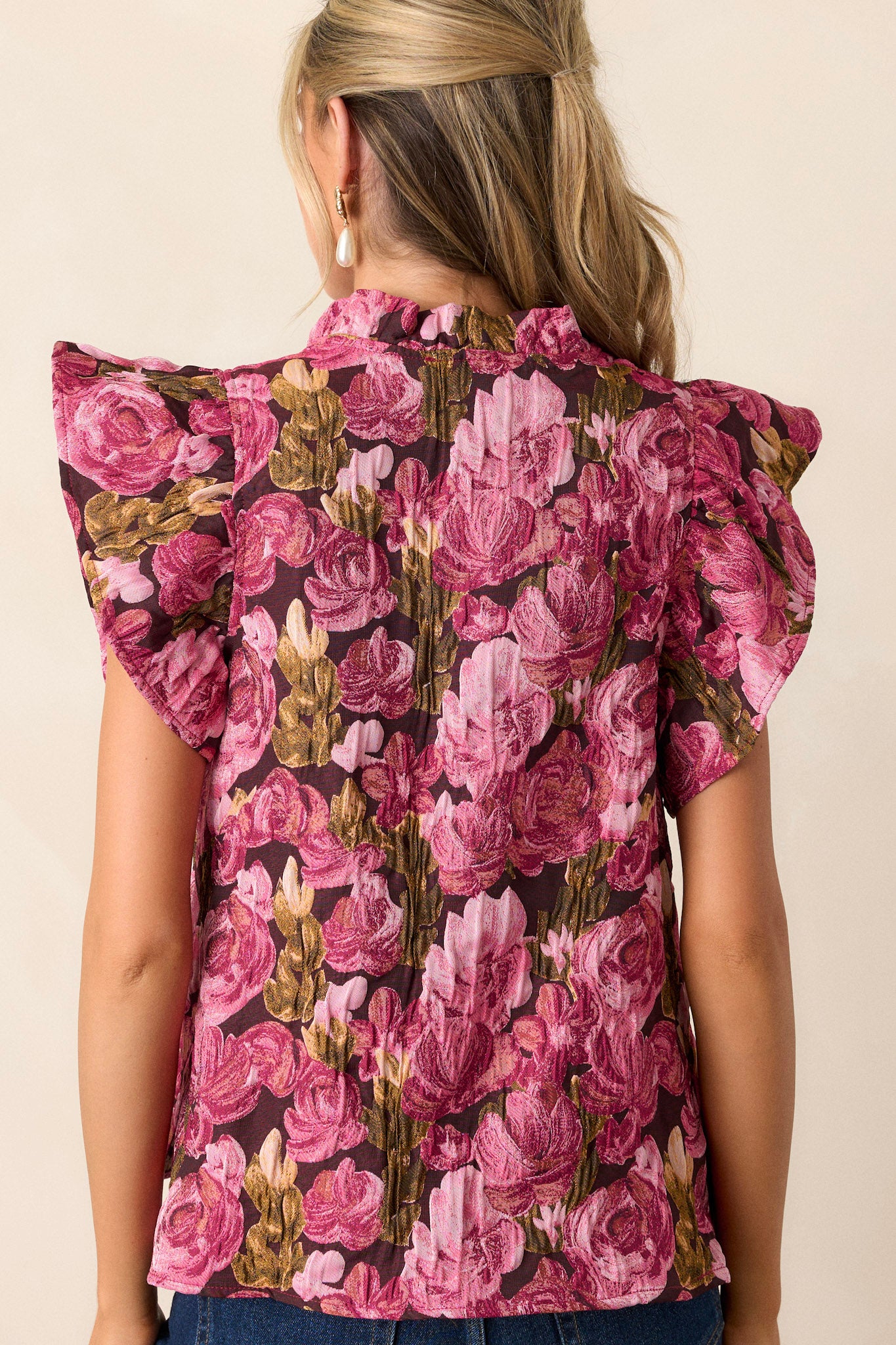 Back view of the berry top highlighting the smooth finish of the floral jacquard fabric and the structure of the short flutter sleeves.