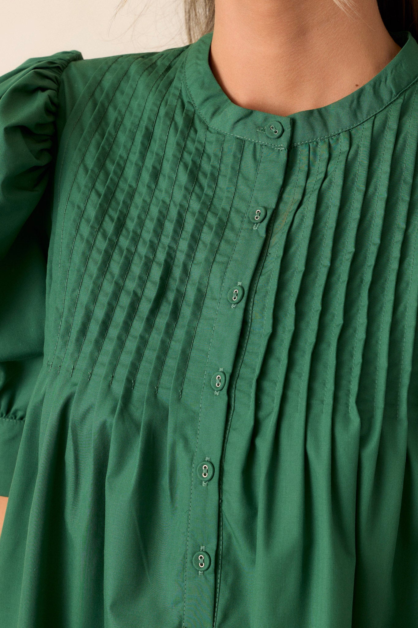 Close-up of the dress focusing on the functional button-front, puff sleeves, and the side pocket detail.