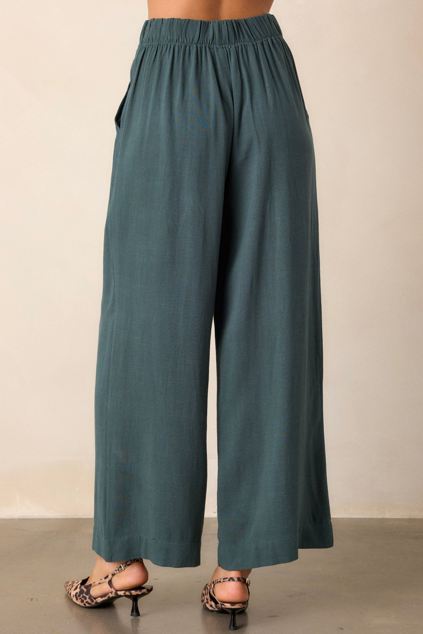 Back view of green pants highlighting the straight leg design and the overall fit of the elastic waist insert