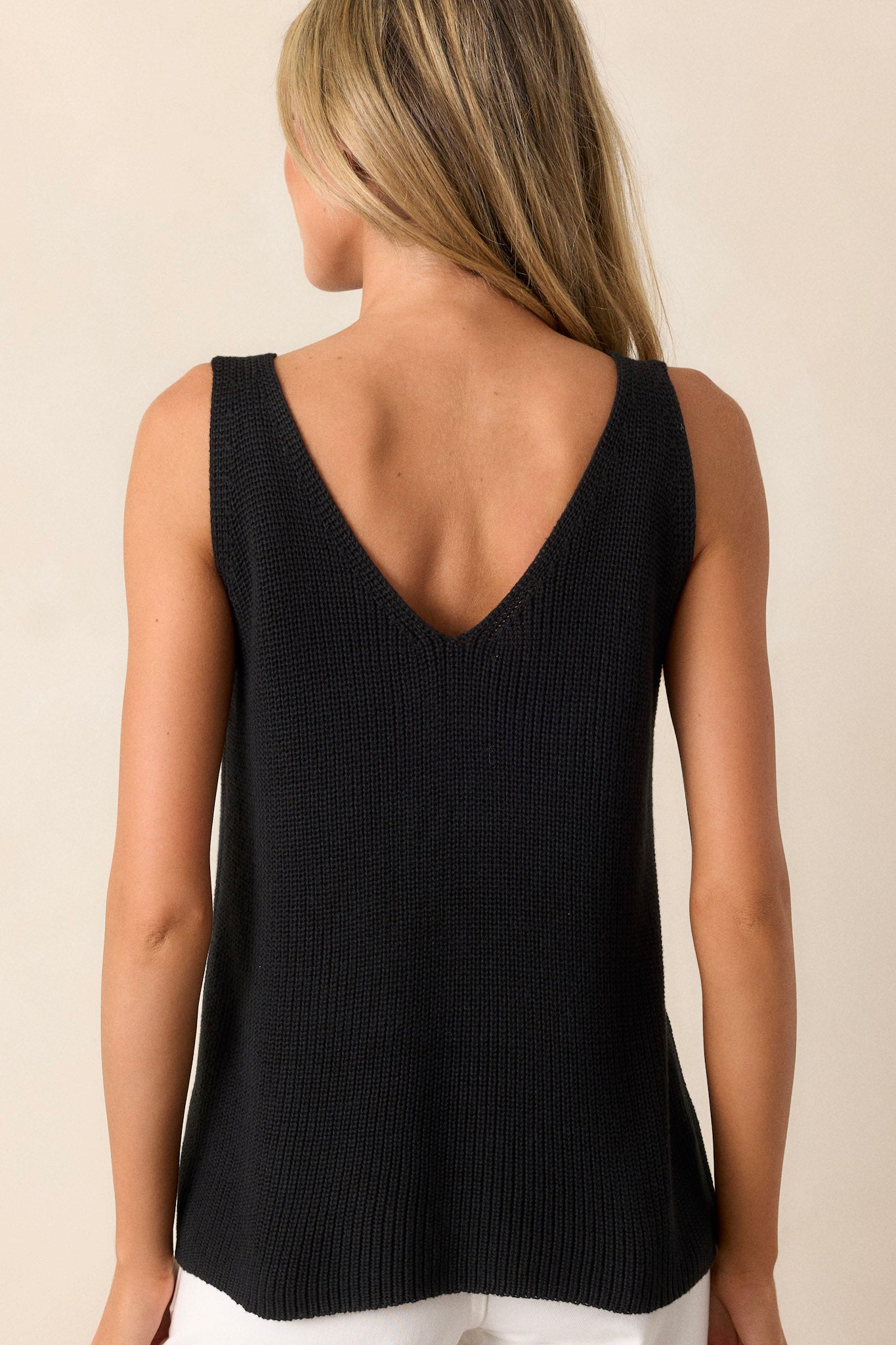 Back view of the black knit tank top highlighting the sleeveless design and the relaxed fit.