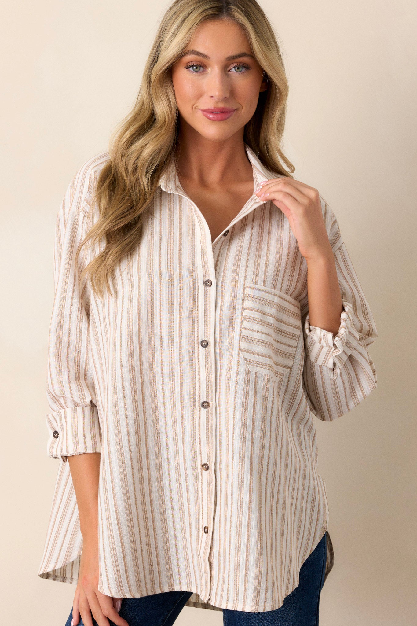 Front view of a top featuring a delicate ivory color, a button front design, and a collared neckline.