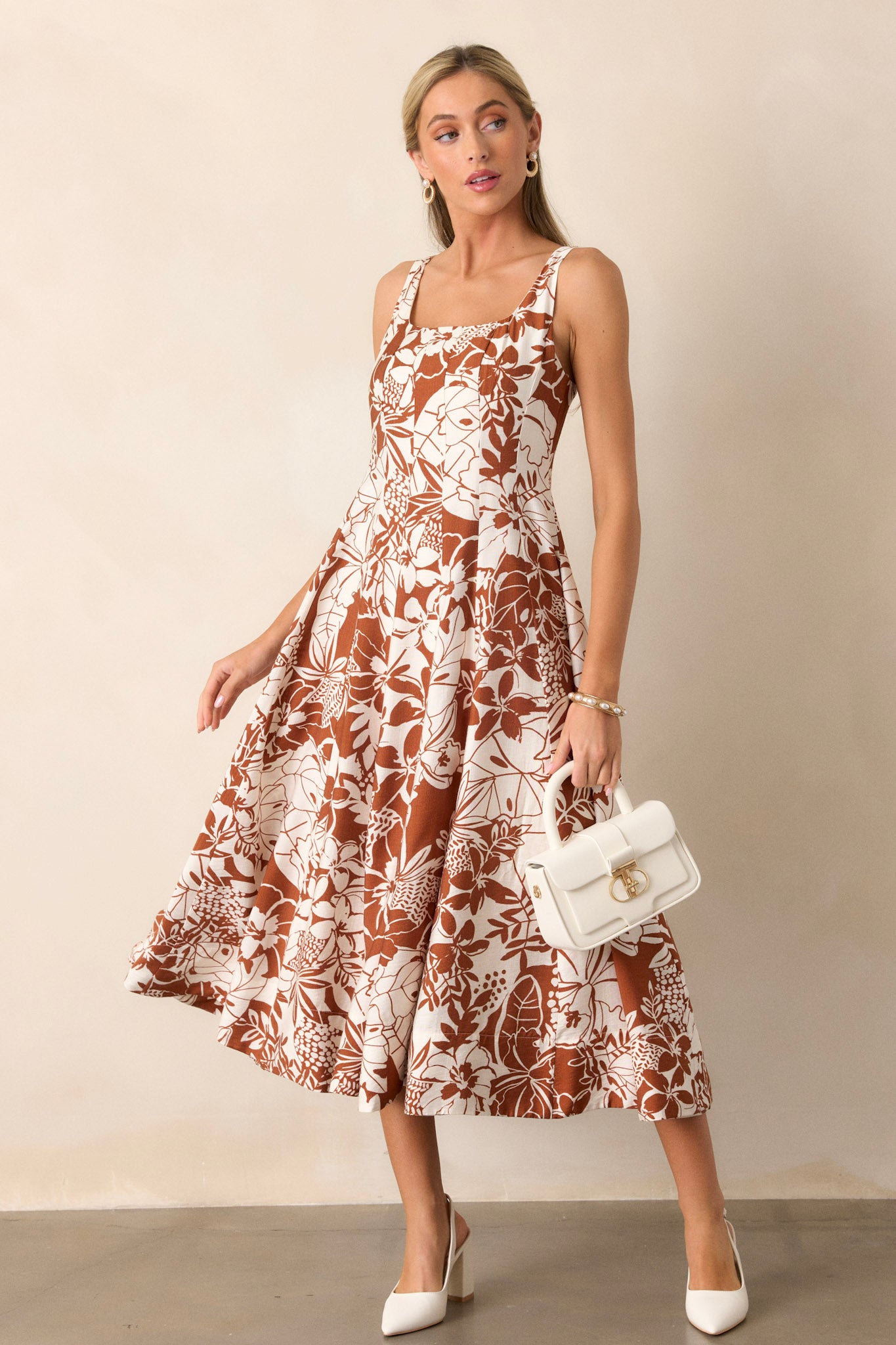 Action shot of the floral dress displaying the flow and movement of the pleated design, emphasizing its comfortable and roomy fit.