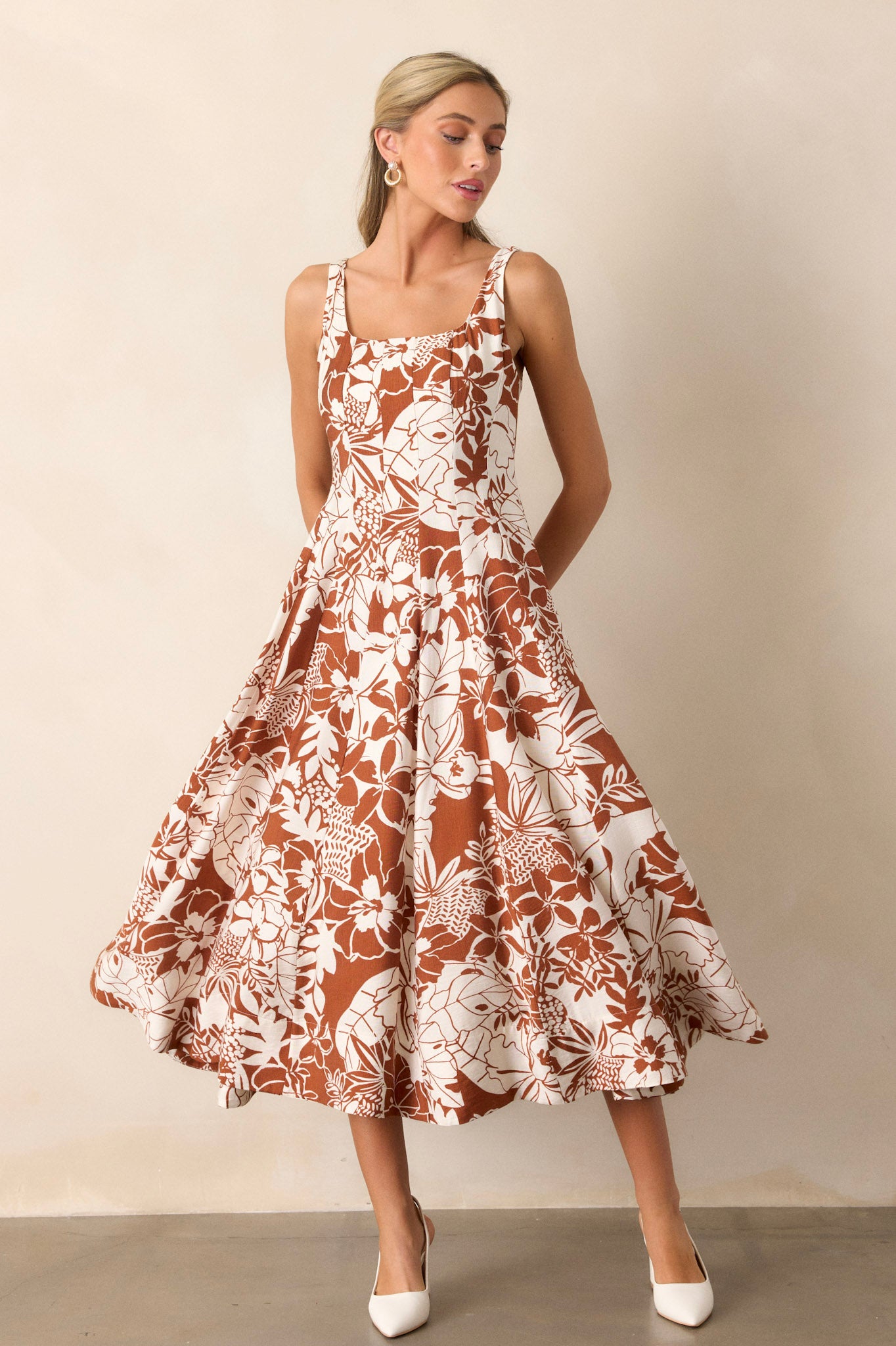 Full length view of the floral dress featuring a pleated design for comfort and room, with a functional zipper in the back