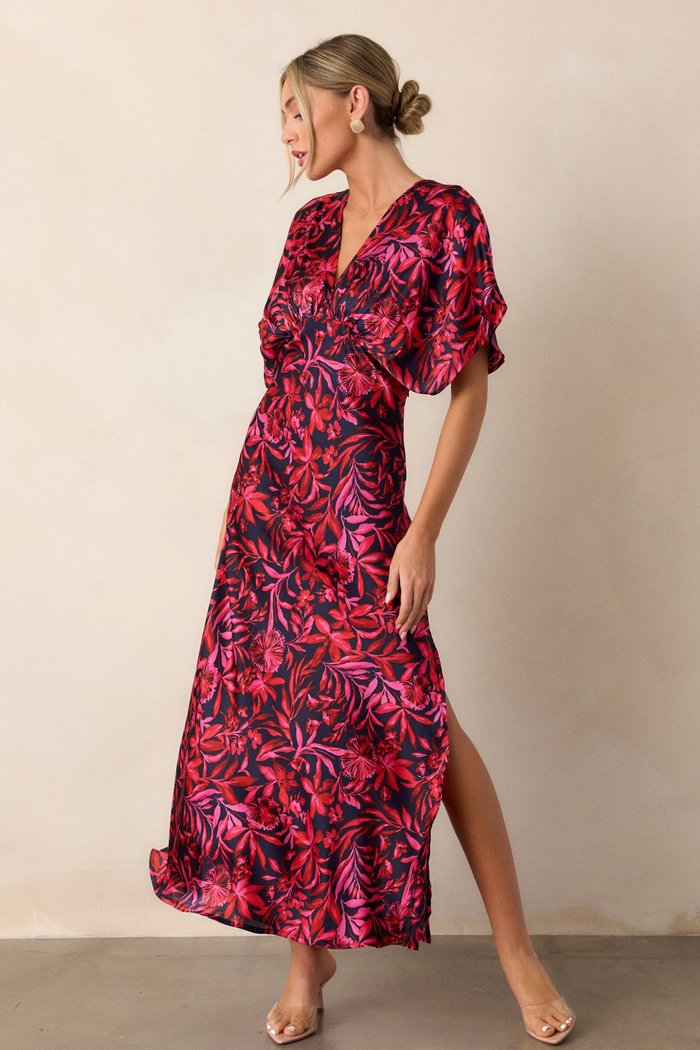 This black floral dress features a side zipper, a deep plunge v-neck, and silk-like soft fabric.