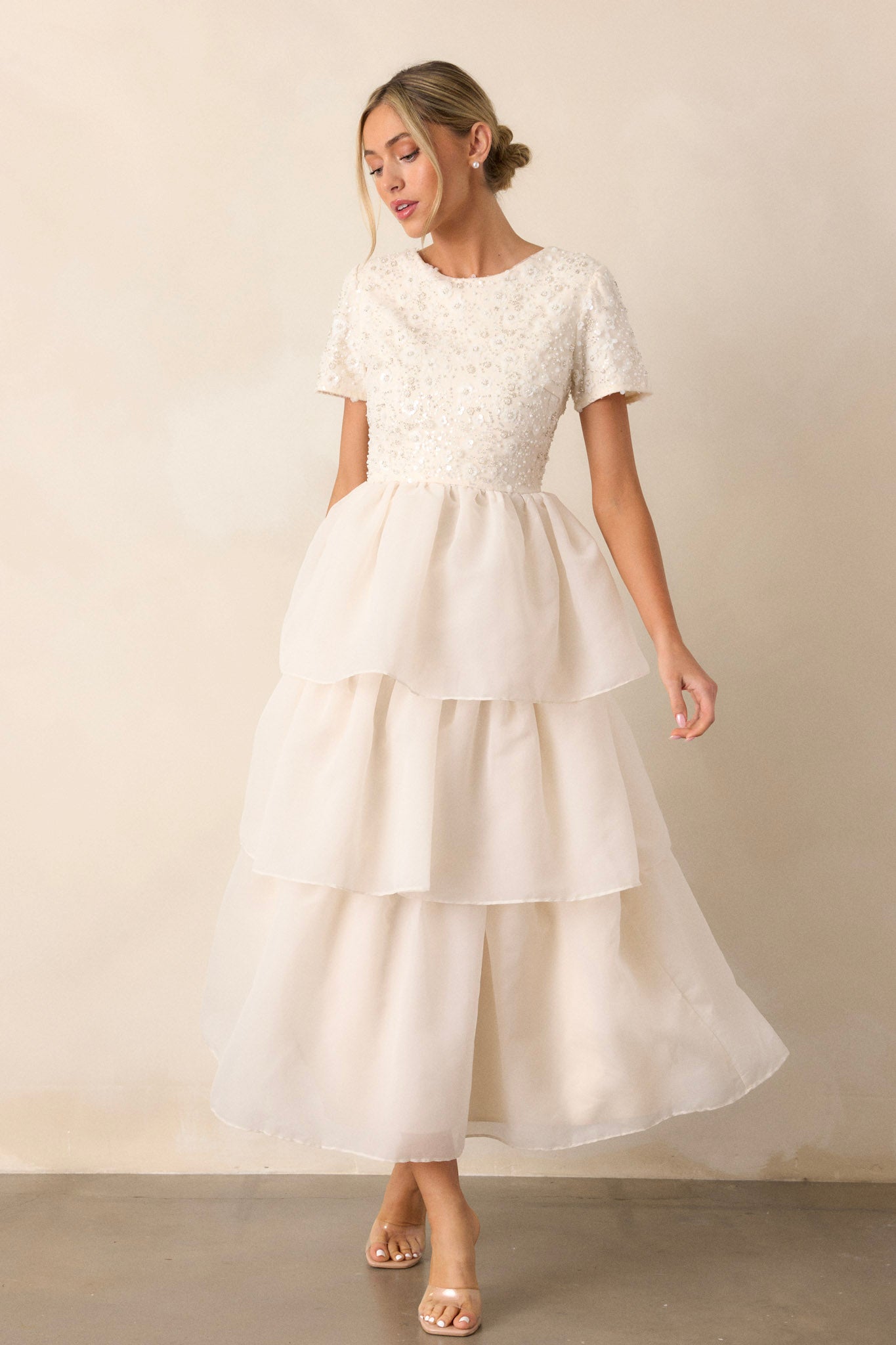 Full-length view of a model wearing the dreamlike dress, emphasizing the tulle tutu-like tiers, pearl details, and the overall ethereal silhouette.