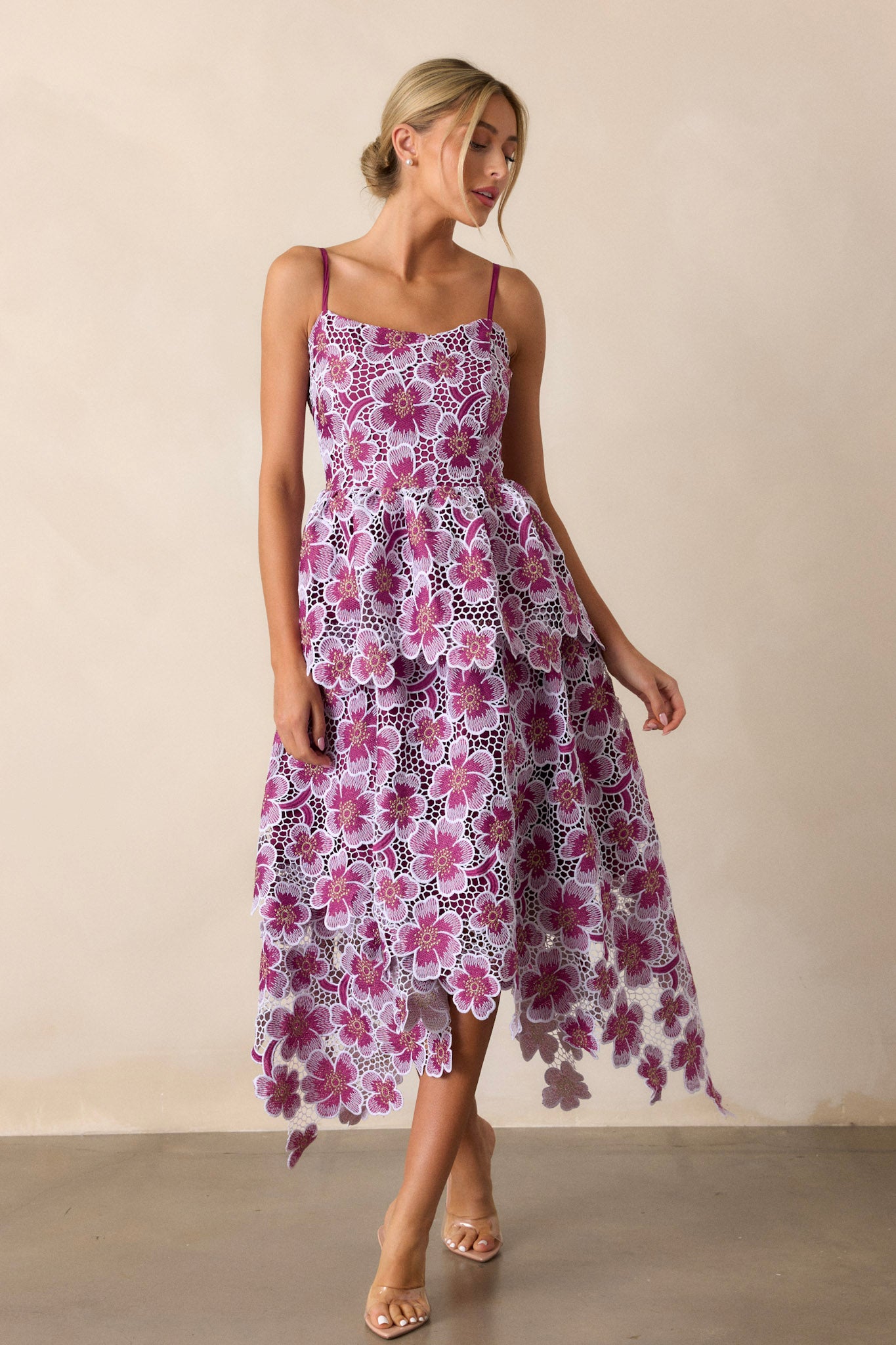 Action shot of the purple dress capturing the playful movement of the fabric and the appliqué florals, with a focus on the adjustable straps and back zipper.