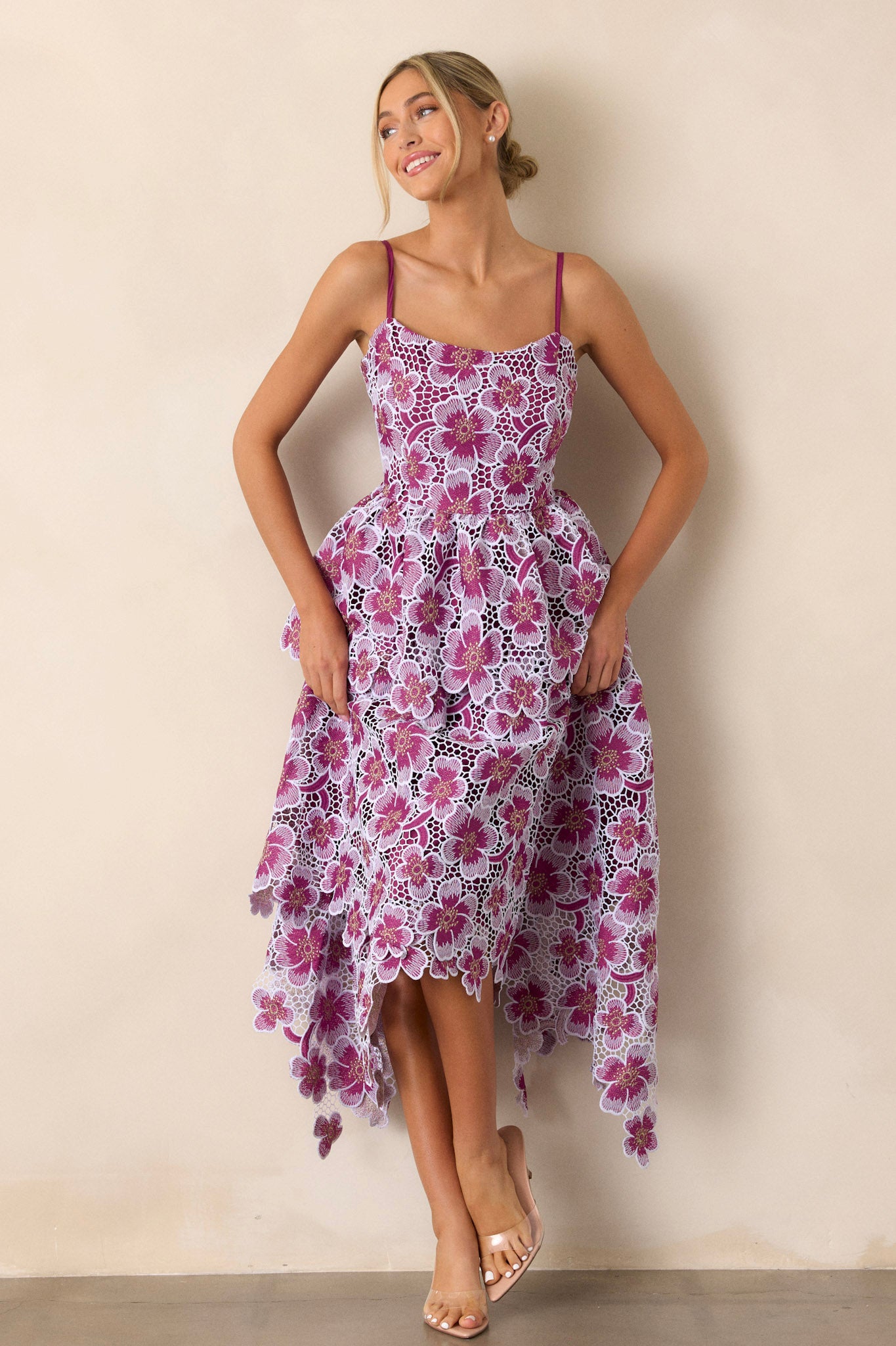 Full-length view of a model wearing the purple dress, emphasizing the adjustable straps, the back zipper, and the playful appliqué florals