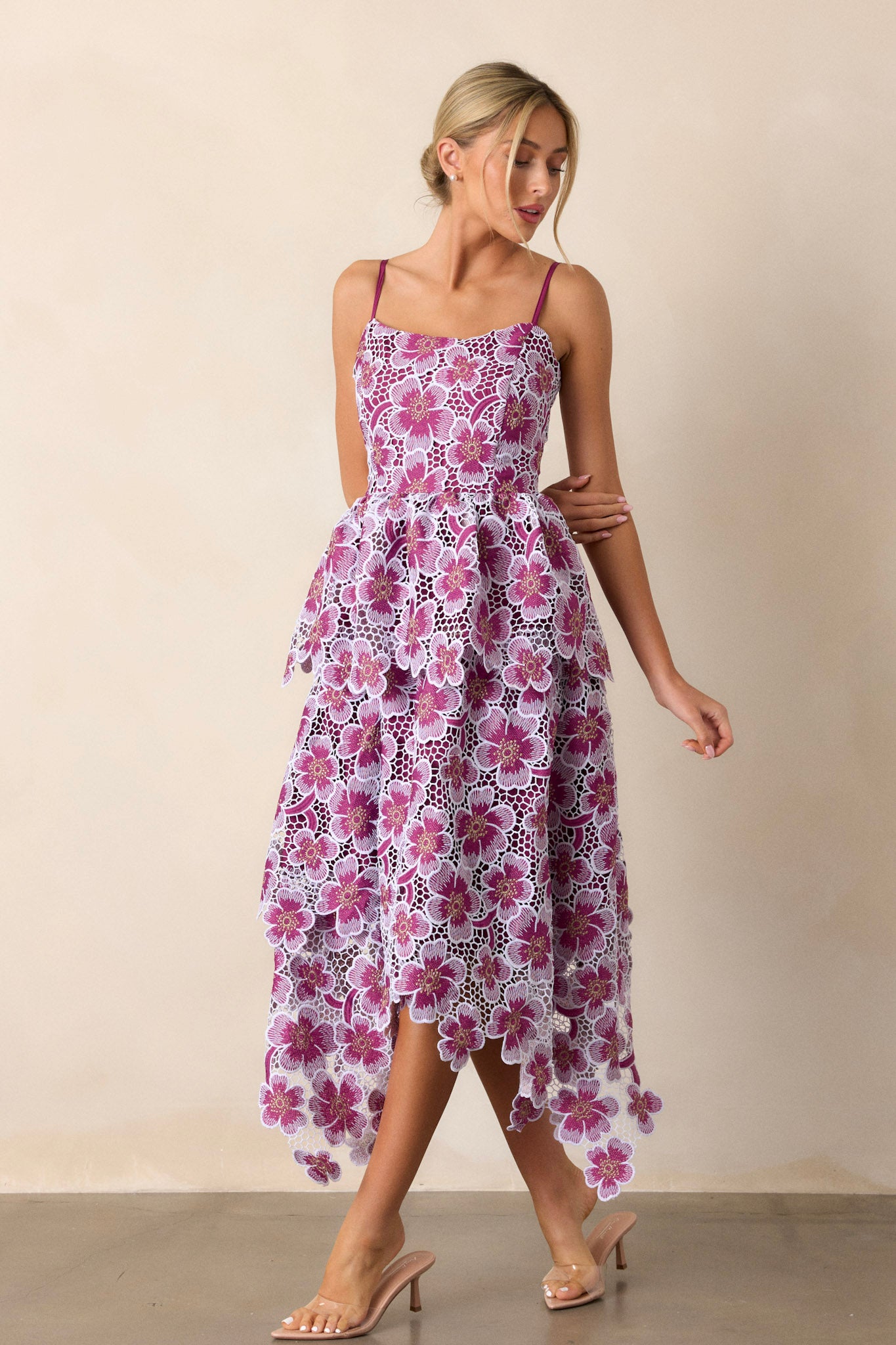 Front view of a purple dress featuring adjustable straps, a back zipper, and fun, funky purple appliqué florals decorating the dress.