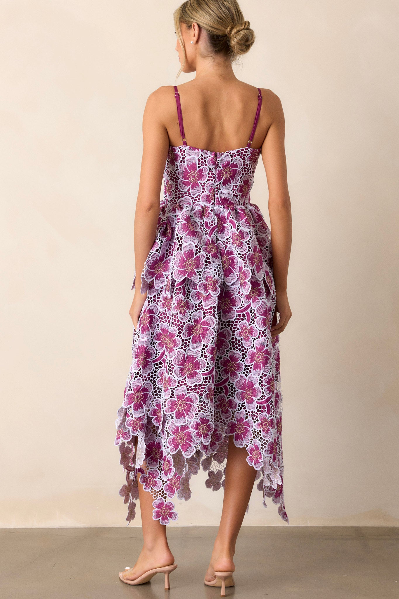 Back view of the purple dress highlighting the zipper and the adjustable straps, with the appliqué florals subtly visible from behind