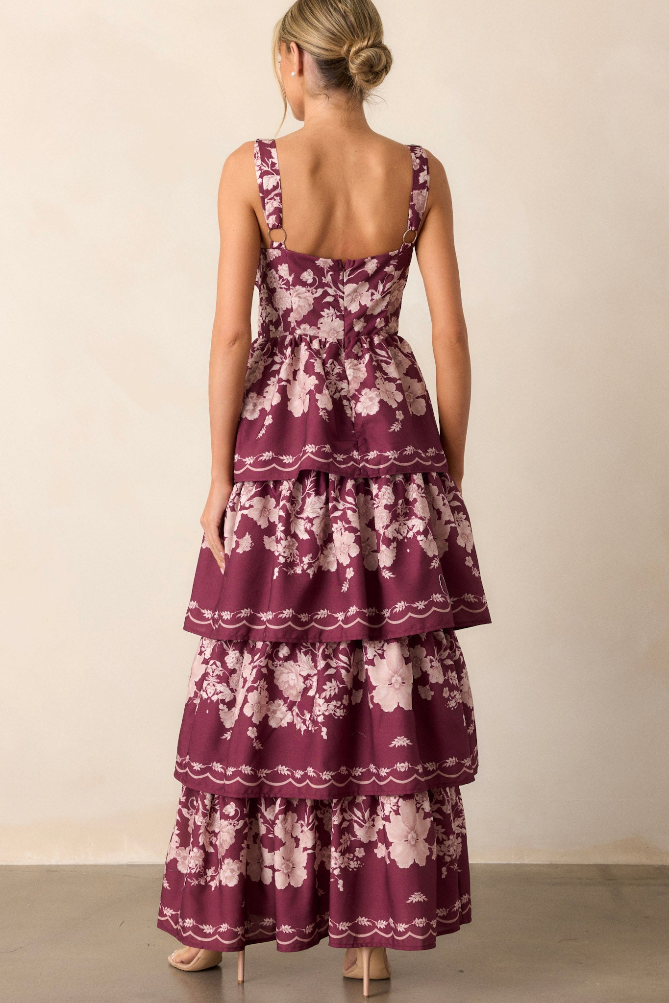 Back view of the wine dress highlighting the back functional zipper and the flowy tiers falling gracefully down the dress