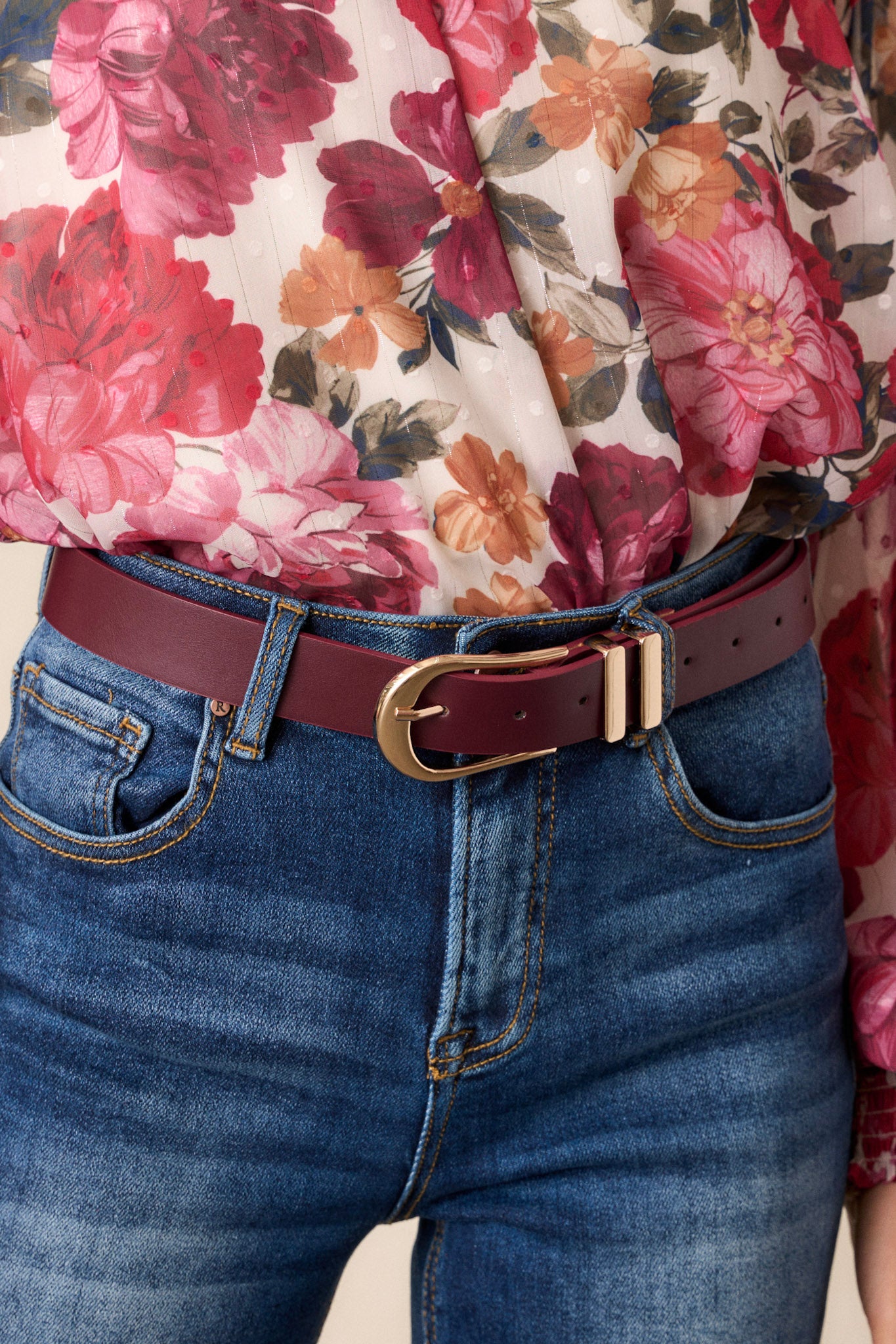 This red merlot belt features a functional buckle, gold trendy hardware, and multiple belt holes to adjust to your liking.