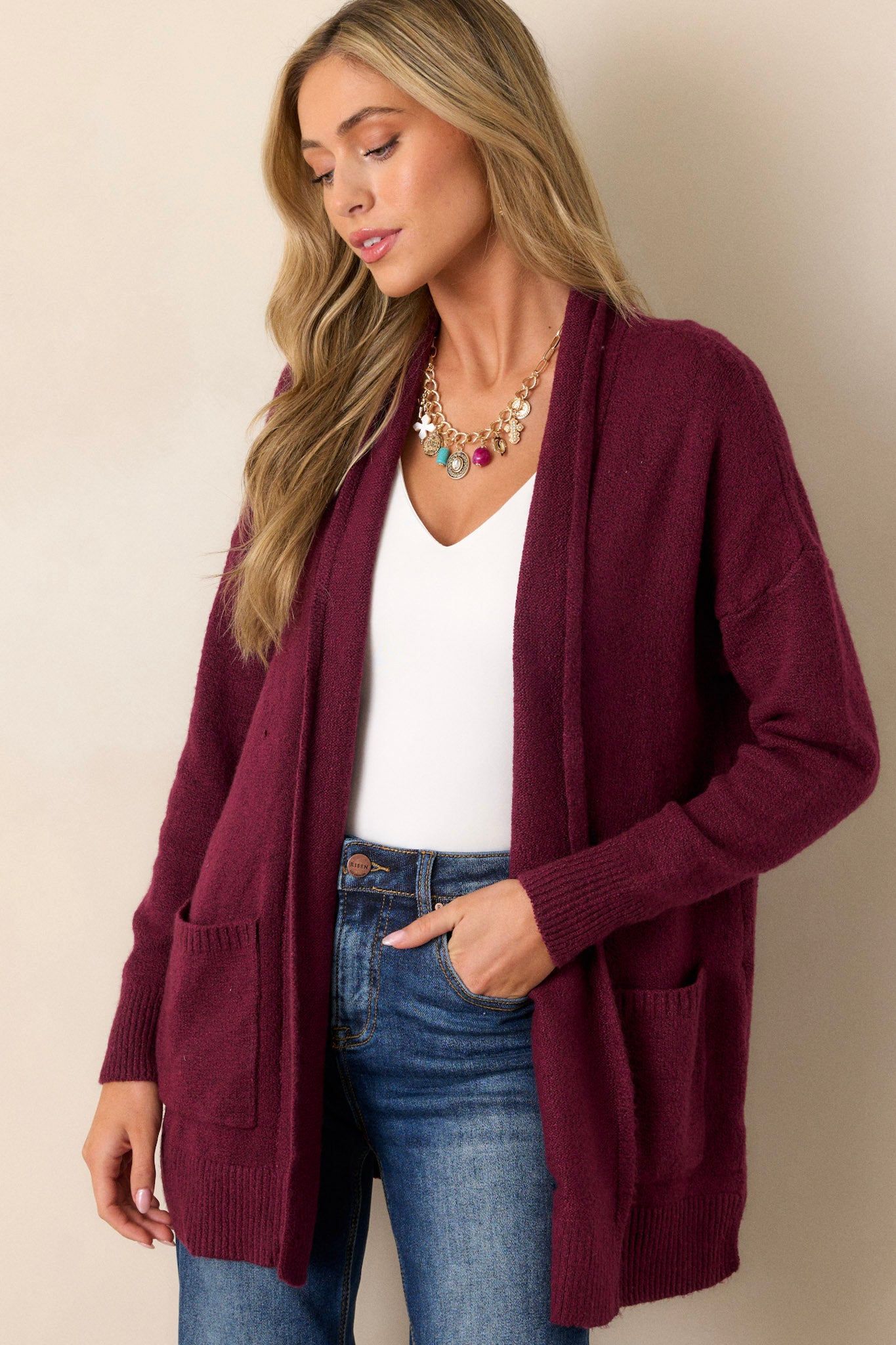 Full length view of a berry cardigan featuring front pockets, an oversized cozy fit, and soft knit fabric