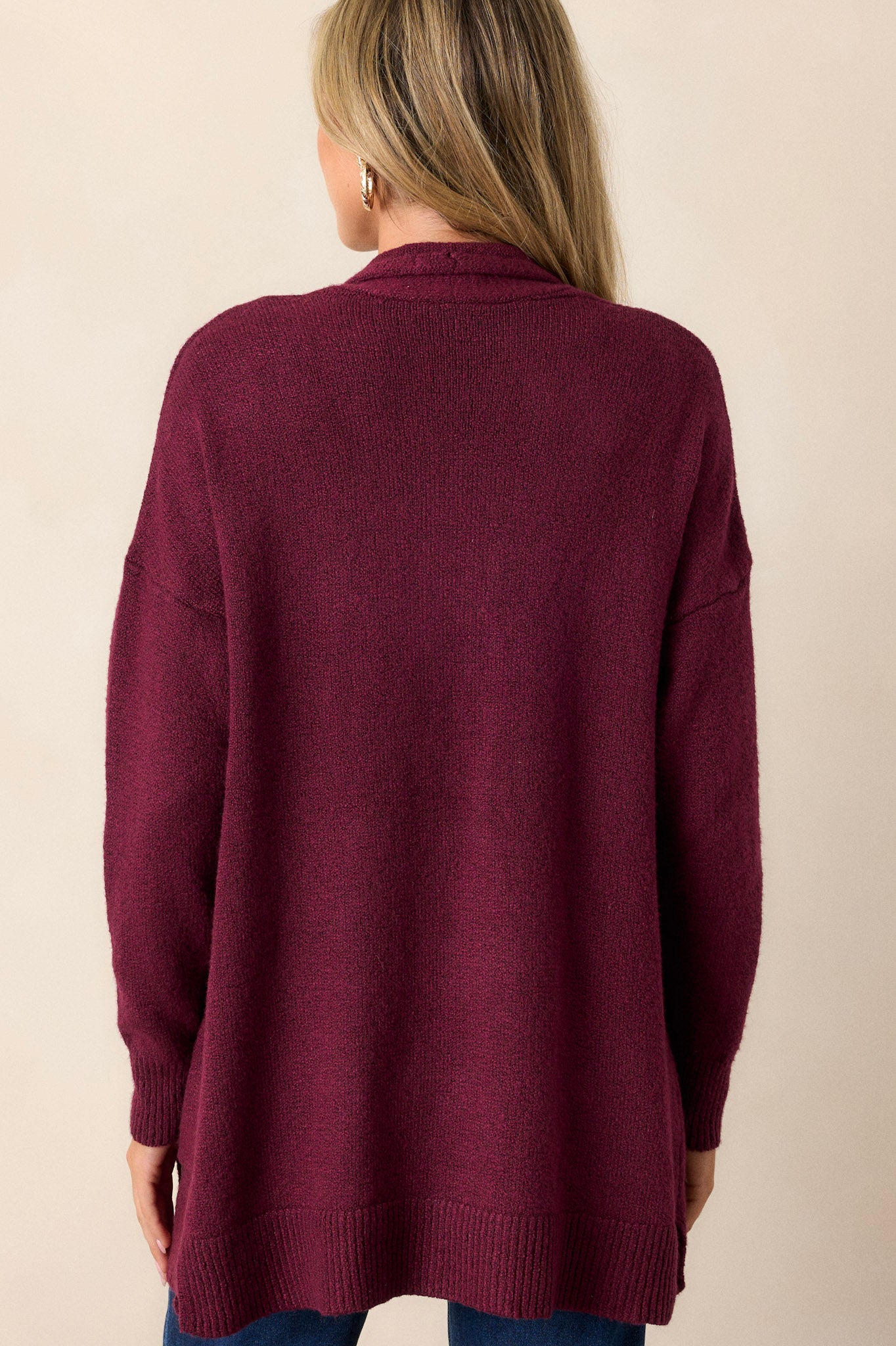 Back view of the berry cardigan highlighting the oversized fit and the drape of the soft knit fabric.