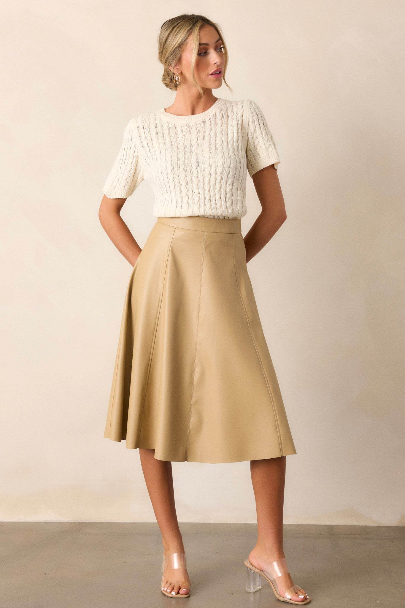 Full length view of the top featuring a soft cable knit design, a ribbed collar, ribbed wrists, and ribbed hips