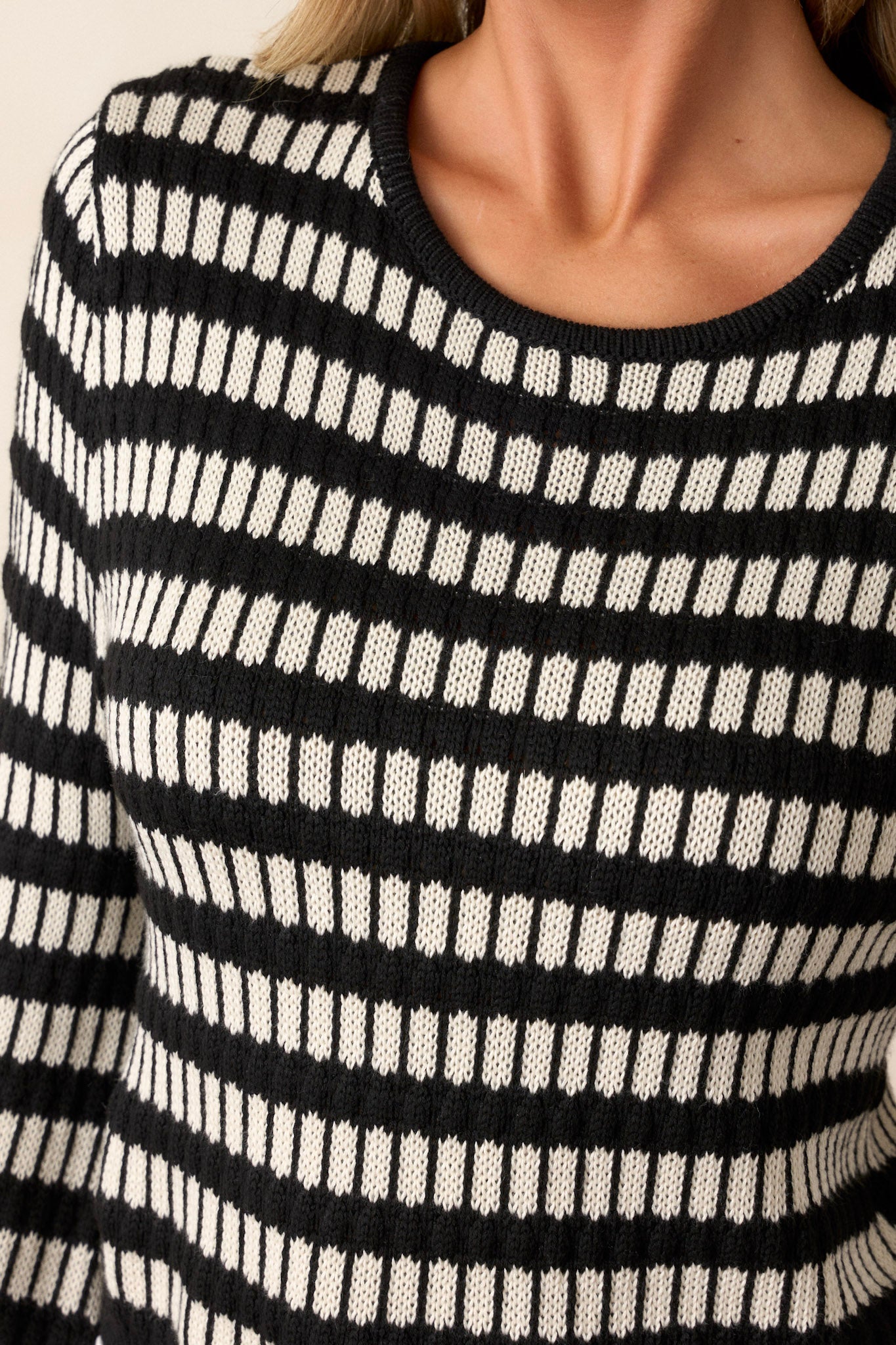 A close-up image focusing on the knit texture, showcasing the intricate weaving and the subtle vertical stripes within the horizontal design.