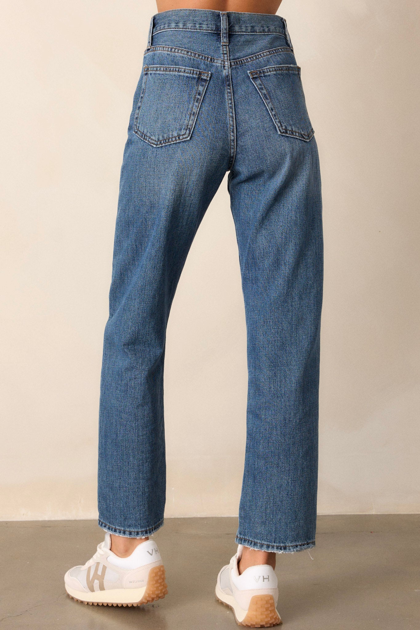 The back view of the jeans, highlighting the pocket placement and the overall fit, providing a complete perspective of the design and silhouette.