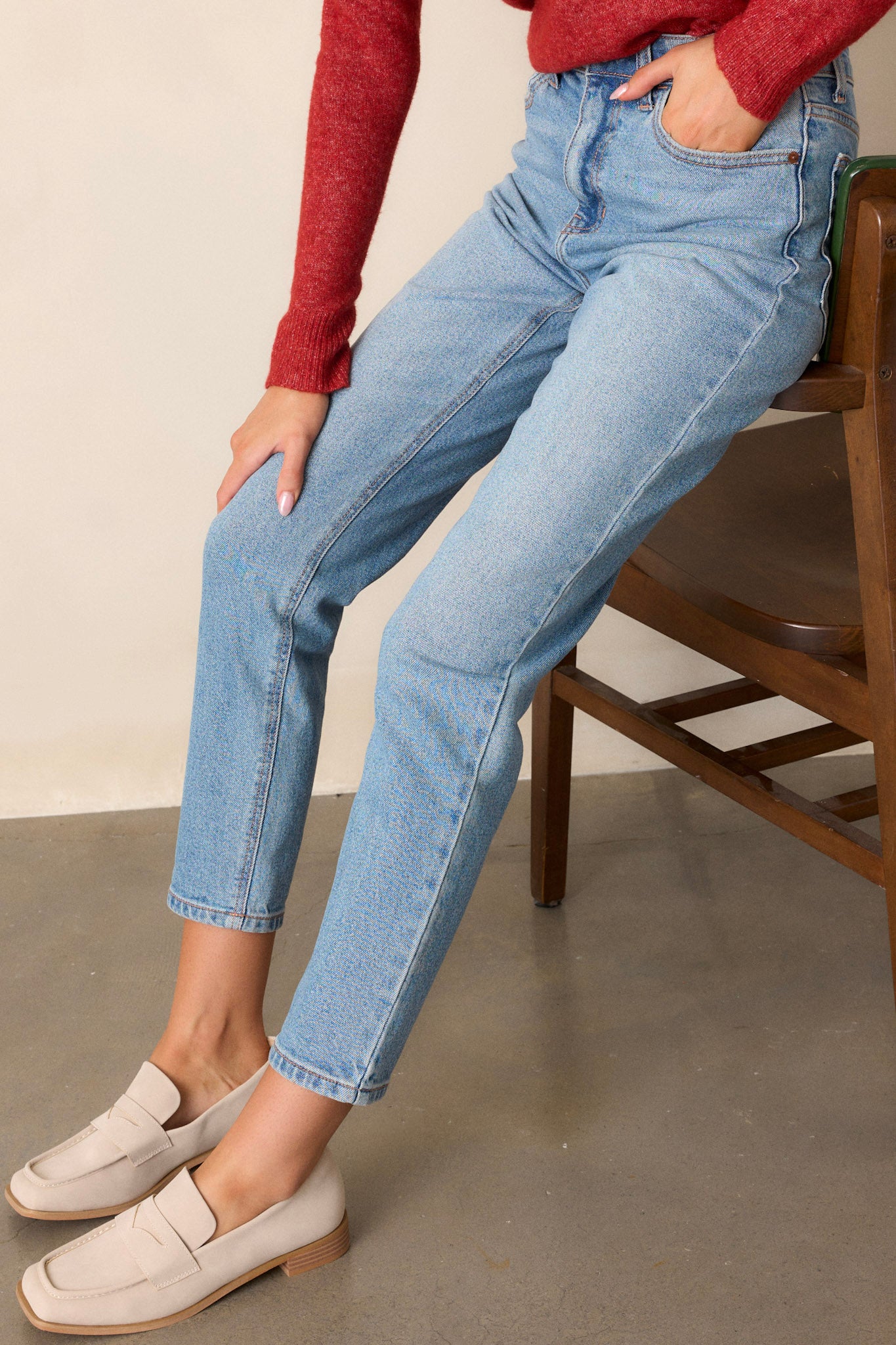 Side view of these medium wash straight leg jeans featuring 5-pocket detailing and a standard zipper and button closure.