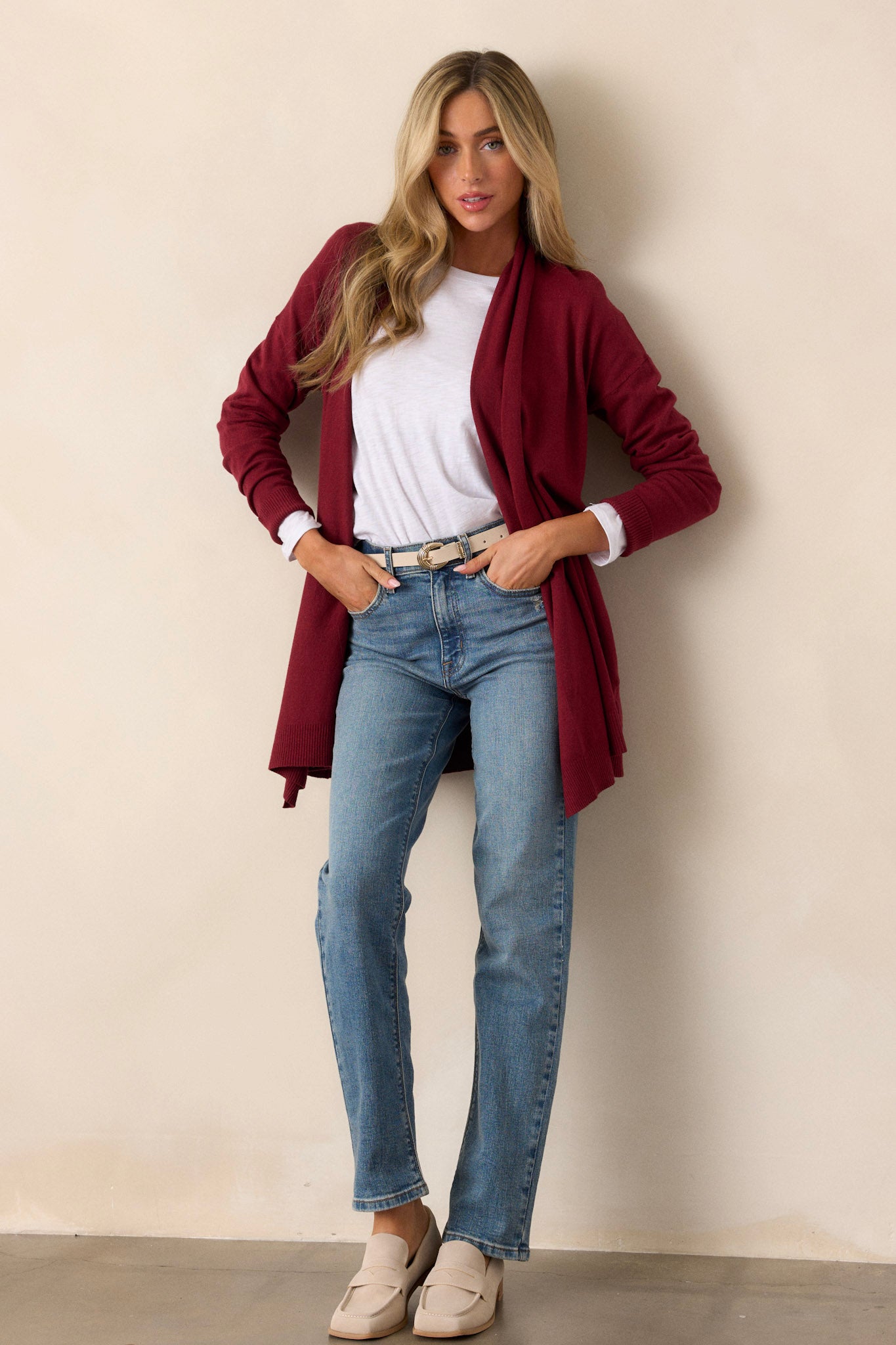 Front view of a cardigan featuring a large slouchy folded collar, ribbed fitted cuffs, and ribbed hemline details.