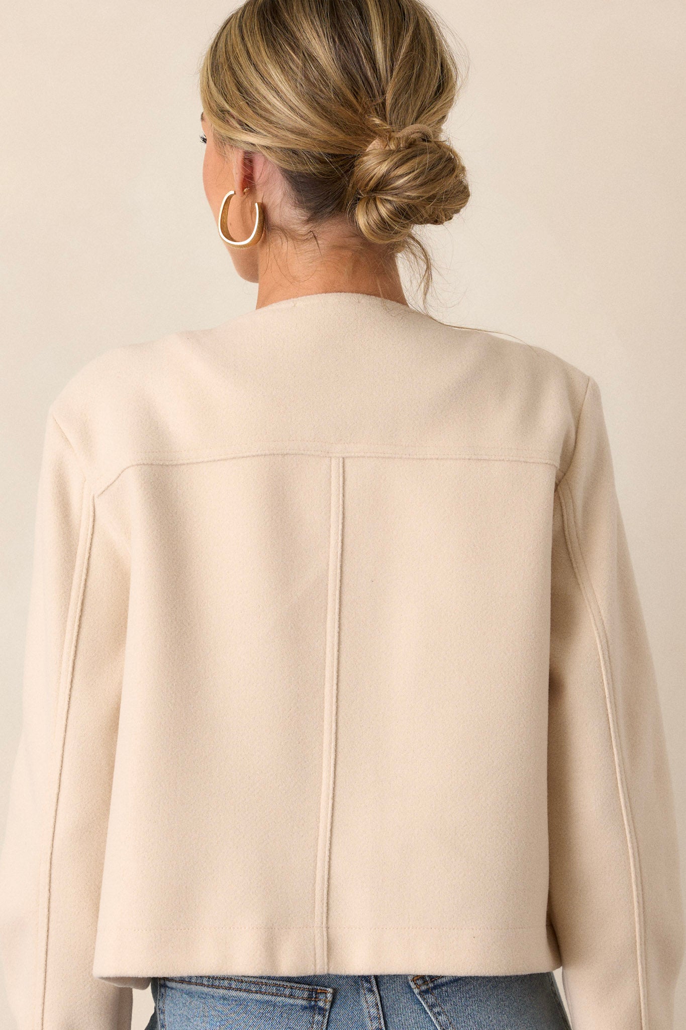 Back of this ivory jacket that features gold hardware, a scoop neck, two functional breast pockets, and a cozy tweed fabric.