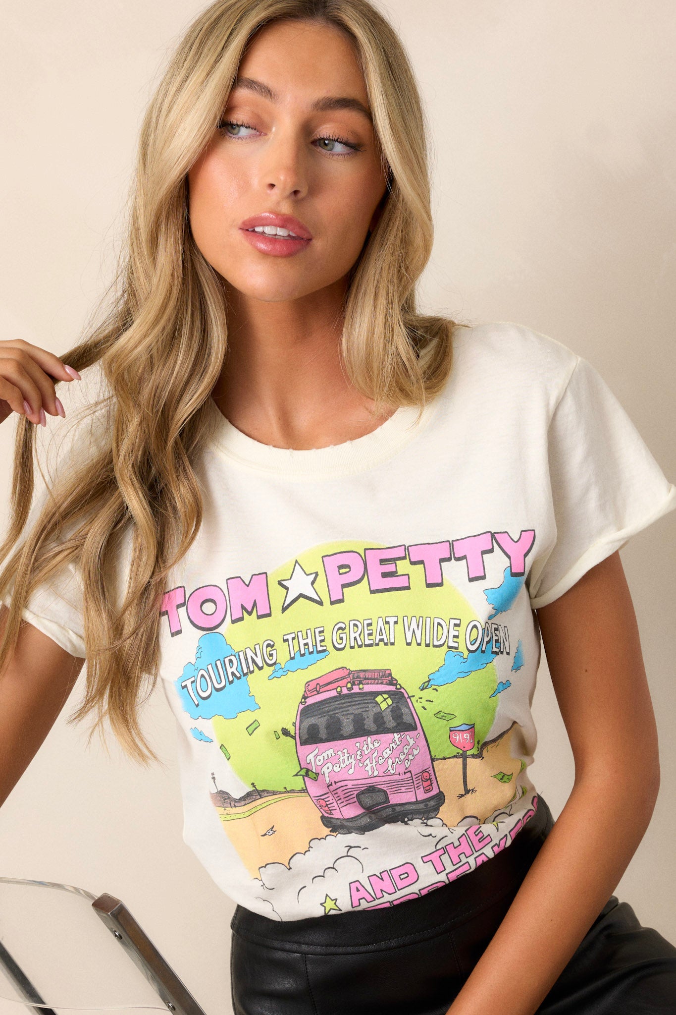 Close-up of the upper section of the ivory tee, emphasizing the printed text 'Tom Petty Touring The Great Wide Open' and the design of the tour bus.