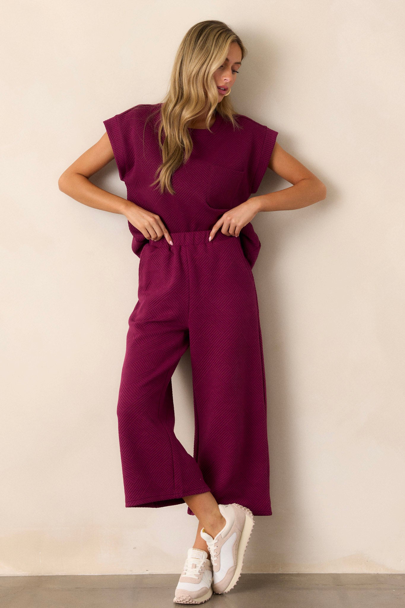 These sangria purple pants feature a high waisted design, an elastic waistband, functional hip pockets, a textured crisscross design, and a wide leg.