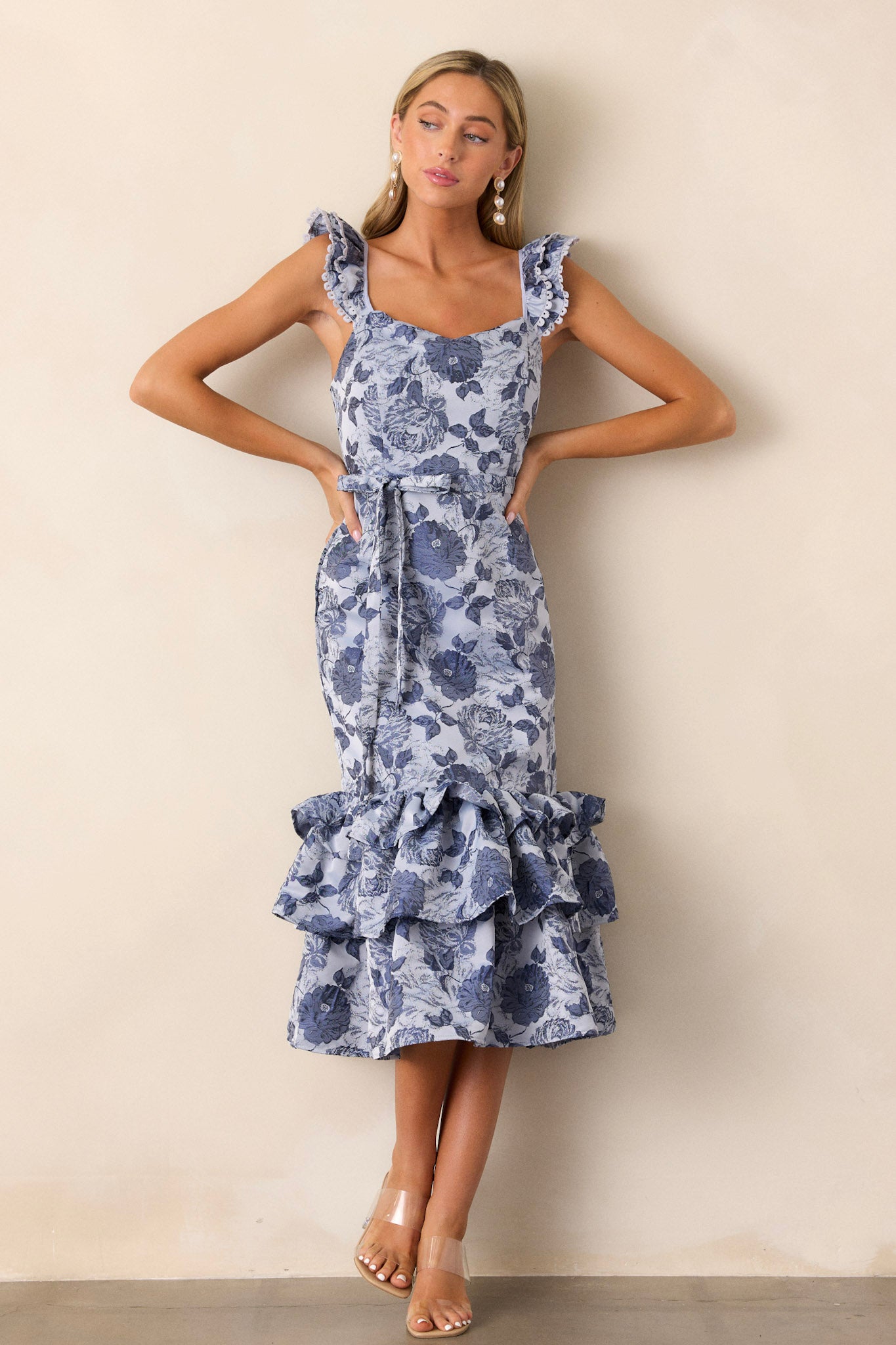 This dress features a ruffled puffy bottom, a functional tie in the back, a scoop neck, and a functional side zipper for easily putting on and off.