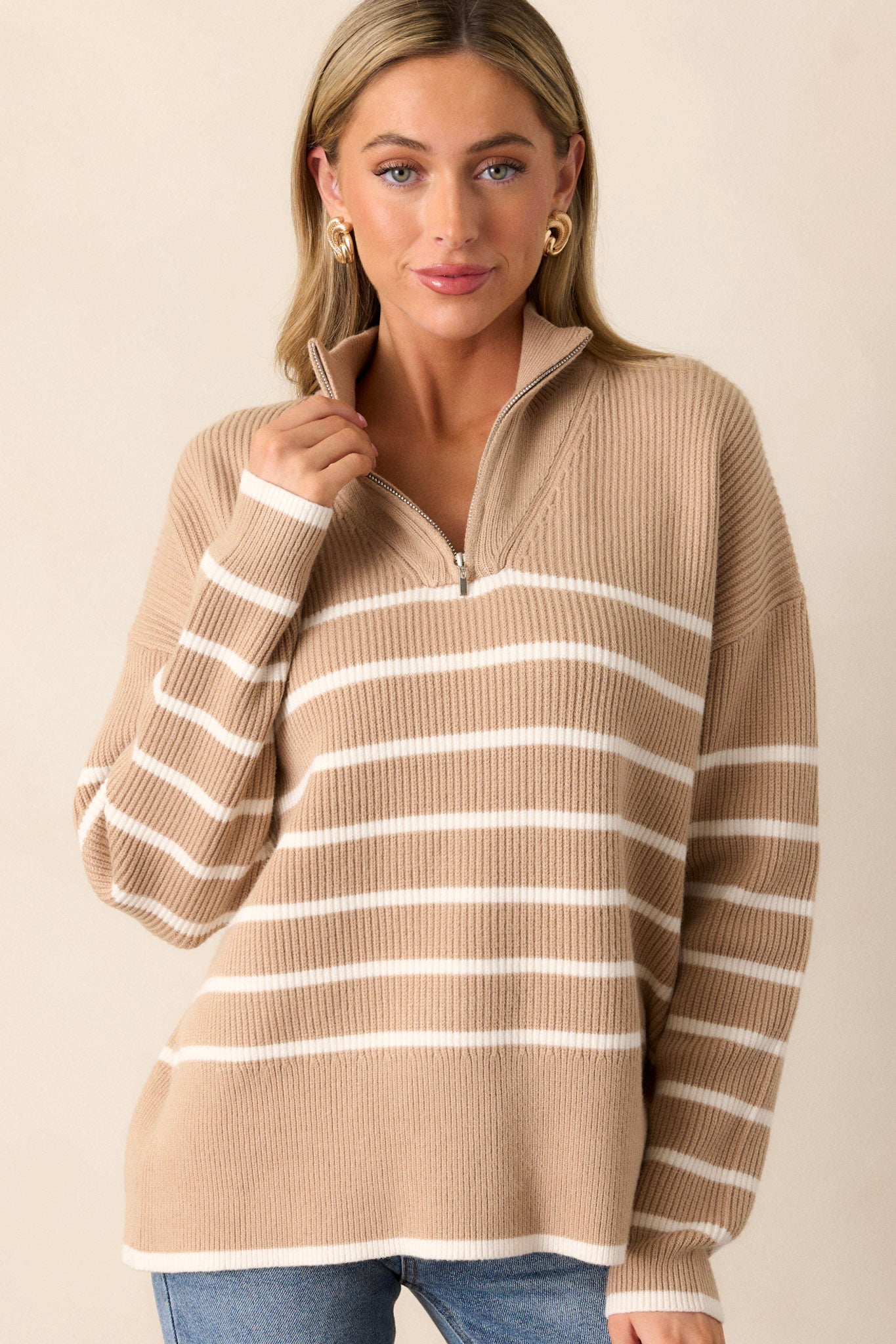 Front view of a playful garment featuring a khaki stripe design, a convenient quarter-zip closure, and a soft knit texture