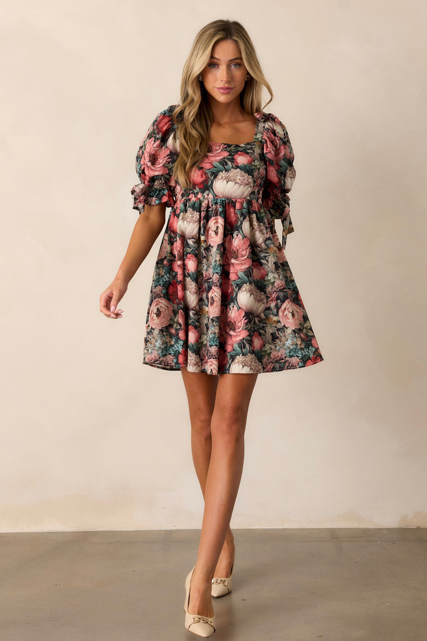 Full length view of the dress featuring puff sleeves with ties, two functional side pockets, and a flowy floral tier