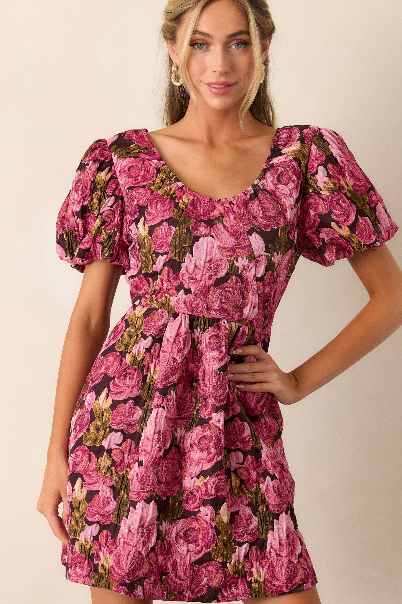 Full length view of this berry dress that features a v-neckline, elastic puff sleeves, a floral jacquard fabric, and a back zipper.