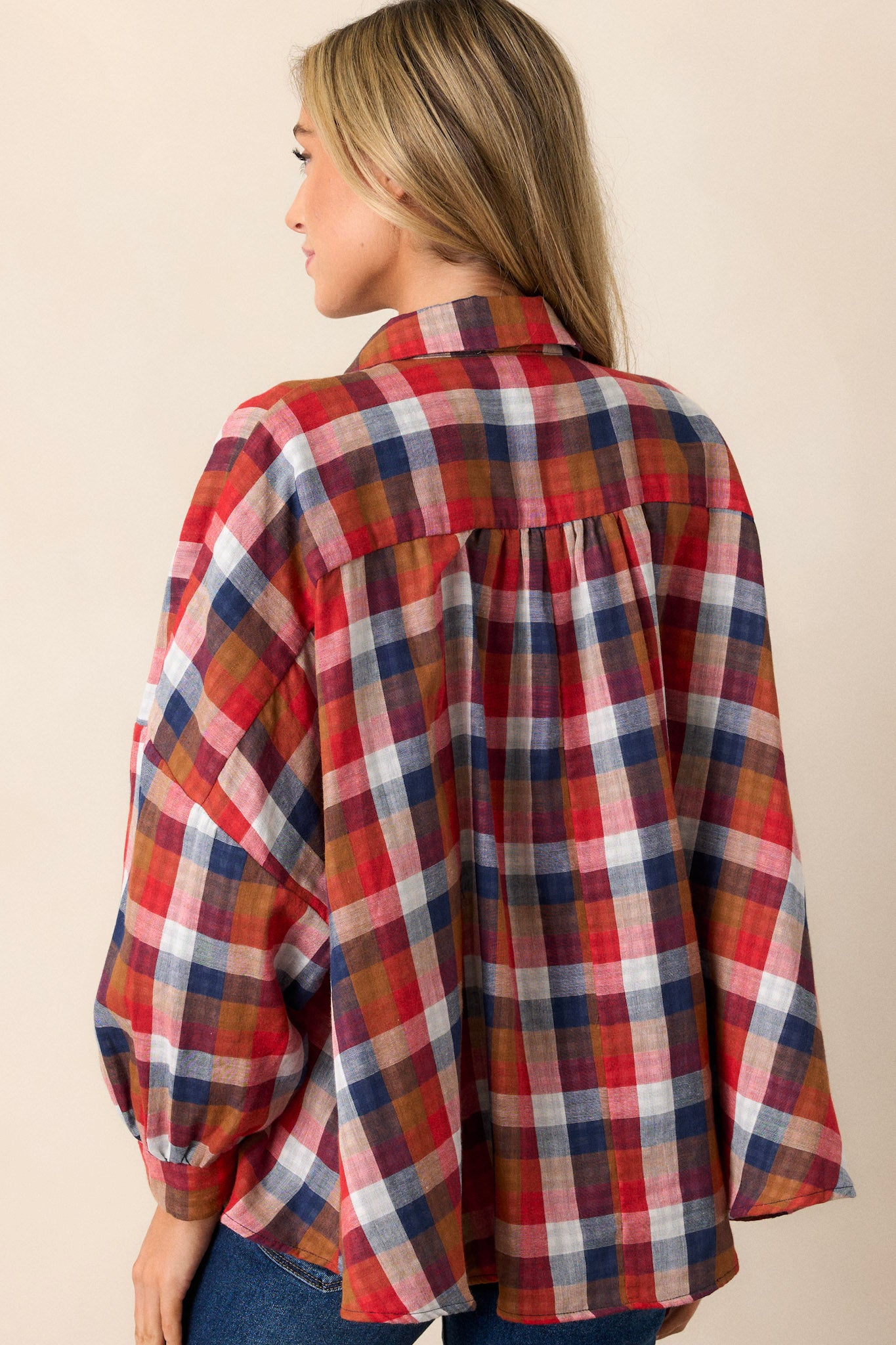 Back view of the top highlighting the relaxed, oversized fit and the straight cut of the hemline, with the subtle detail of the contrasting interior print peeking from the sleeves