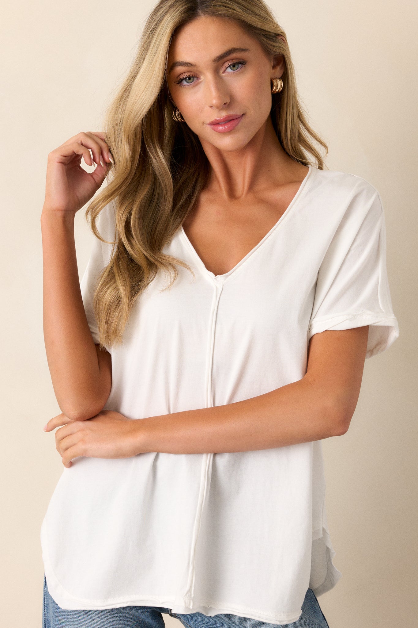 Zoomed-in view of the top highlighting the V-neckline and front vertical hem. The soft drape of the fabric and relaxed silhouette add to its effortless style.