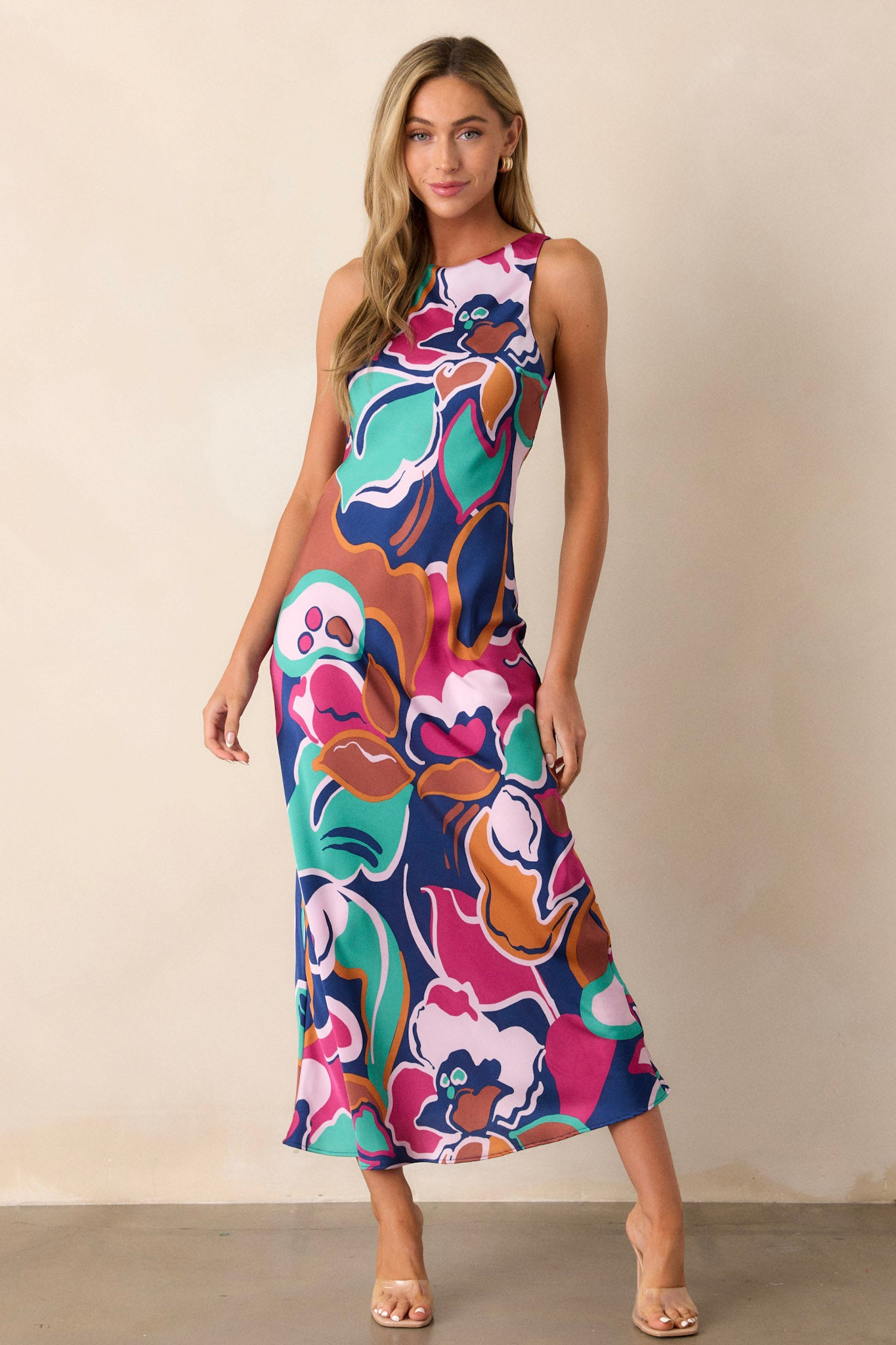 This midi dress features a round neckline, a keyhole button closure, a unique abstract floral print, and a fun midi length.