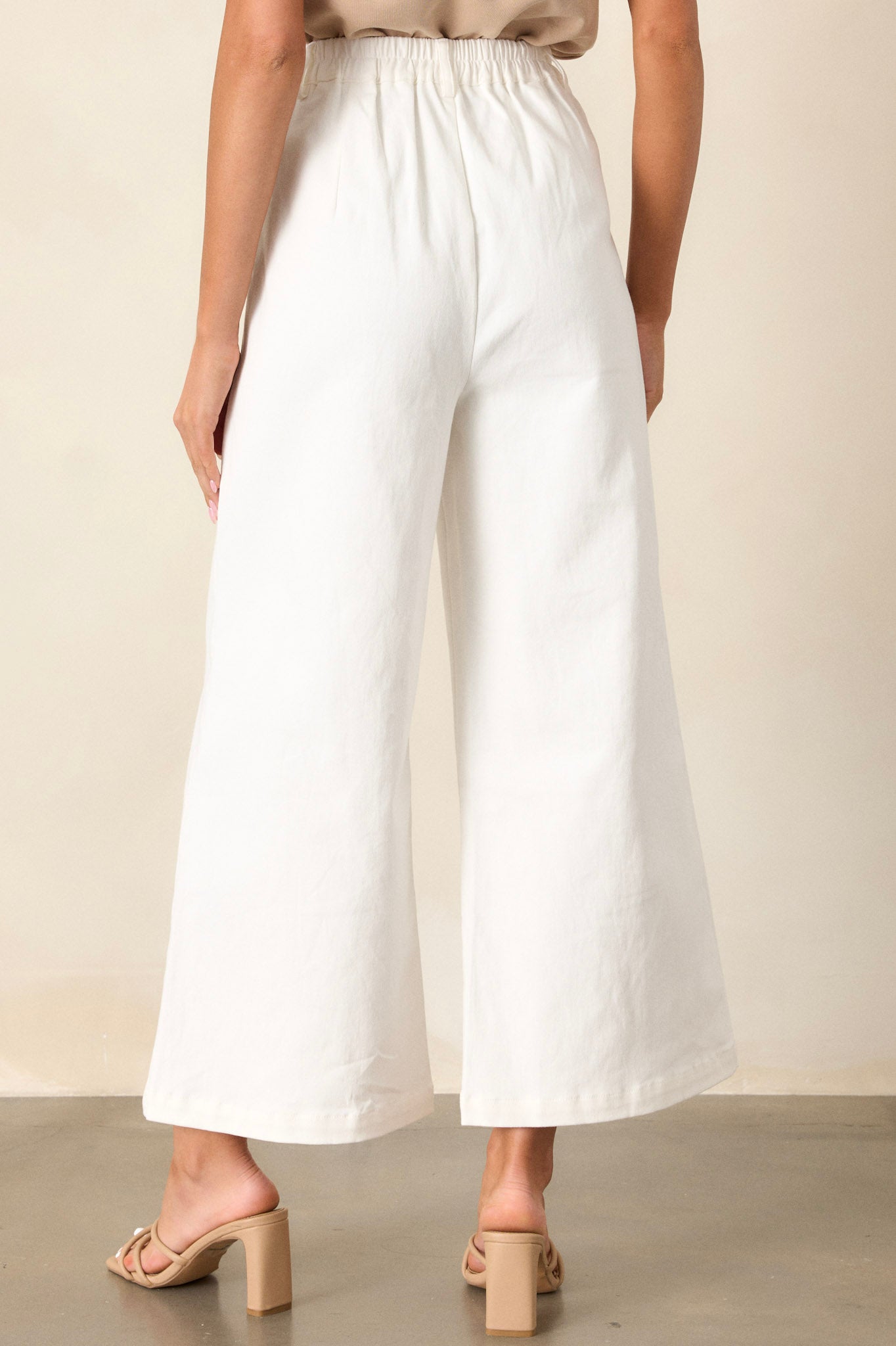 Back view of the wide leg jeans highlighting the elastic waist insert, functional belt loops, and the wide leg cut.