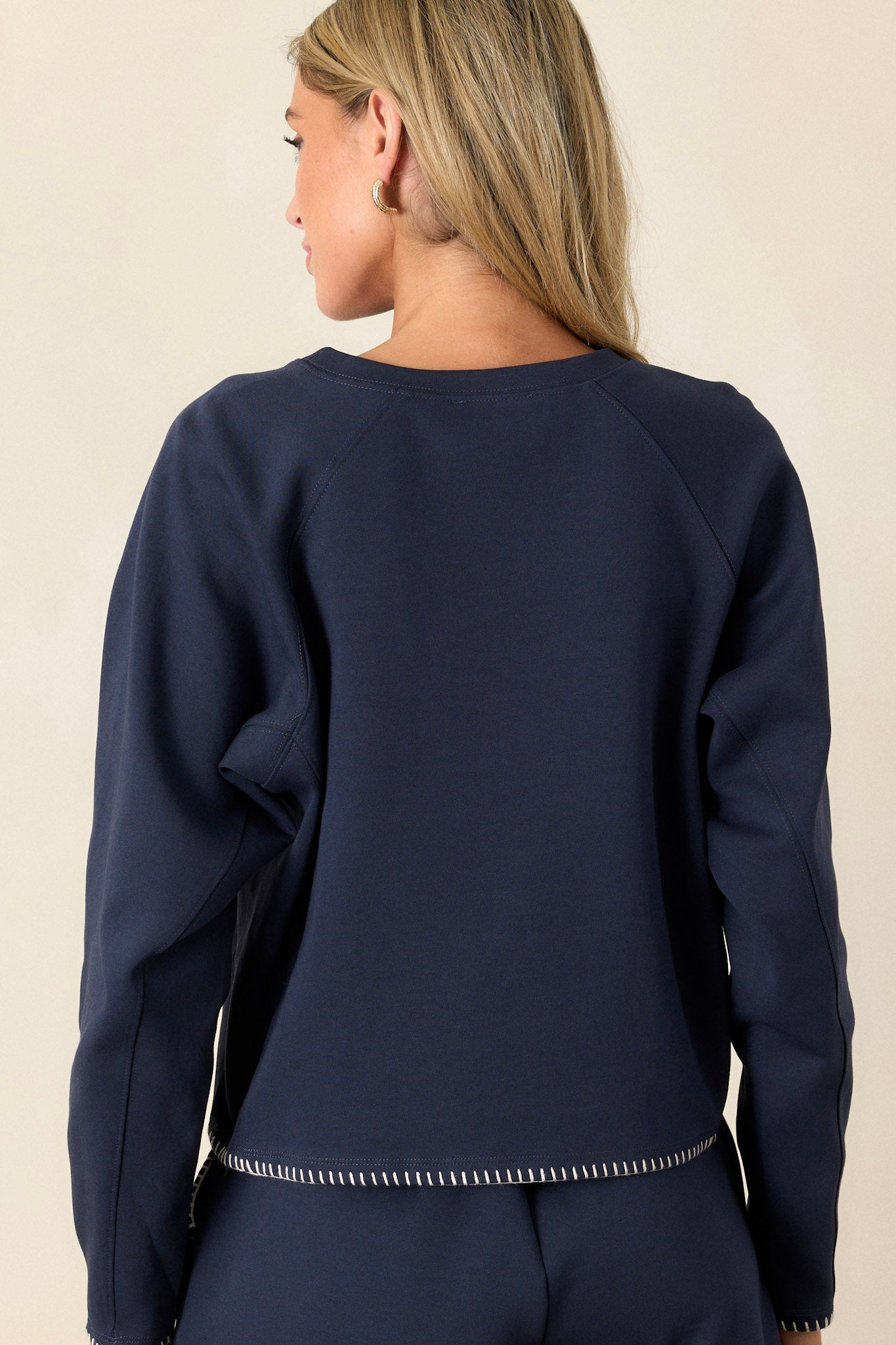 Back view of the top highlighting the simple design with the stitch detailing subtly visible around the cropped hemline.