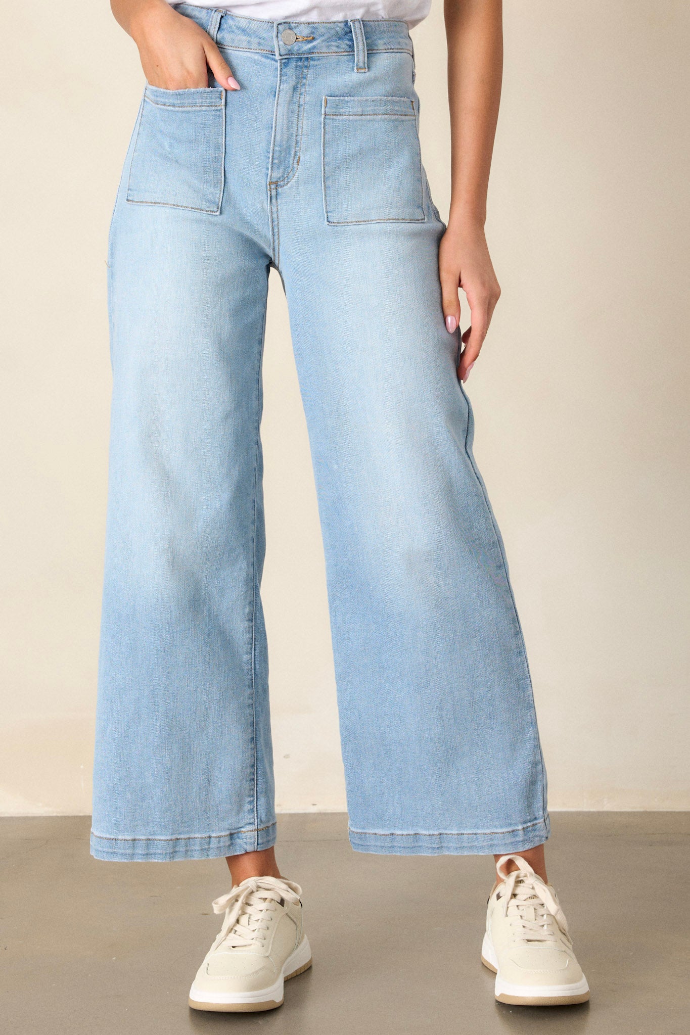 Front view of wide leg jeans featuring functional belt loops, a button and zipper closure, functional front and back pockets, and a wide leg design.