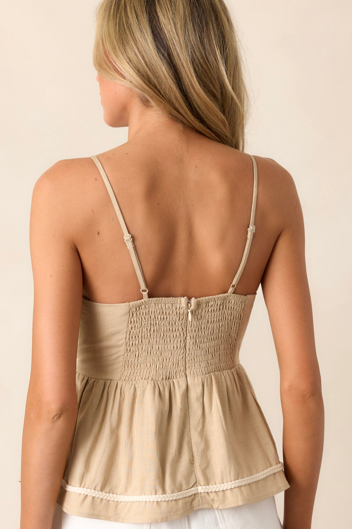 Back view of the top highlighting the smocked back with a functional zipper and the adjustable straps.