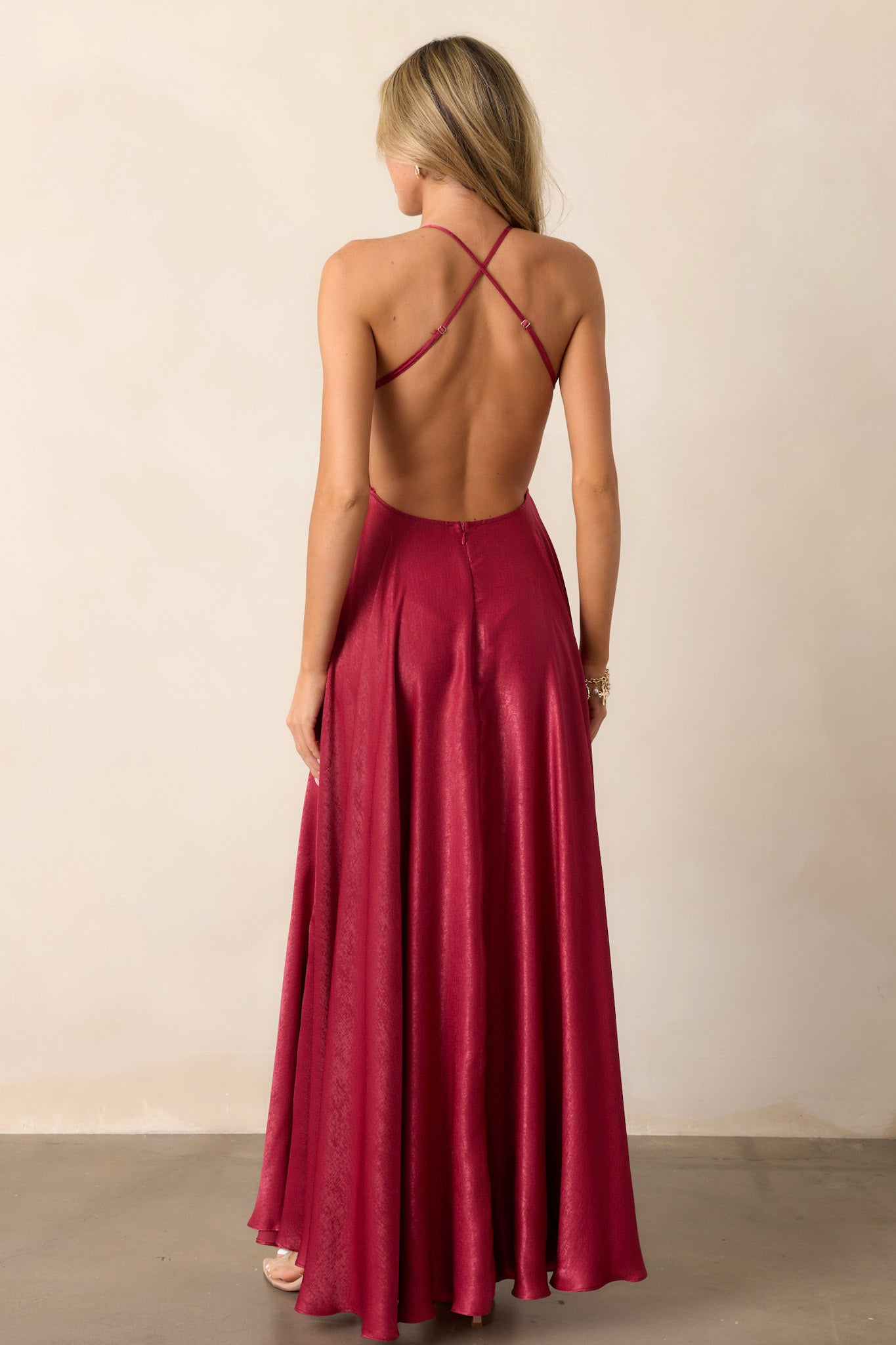 Back view of the cranberry dress highlighting the open back design, the seamless back zipper, and the sleek finish of the dress.