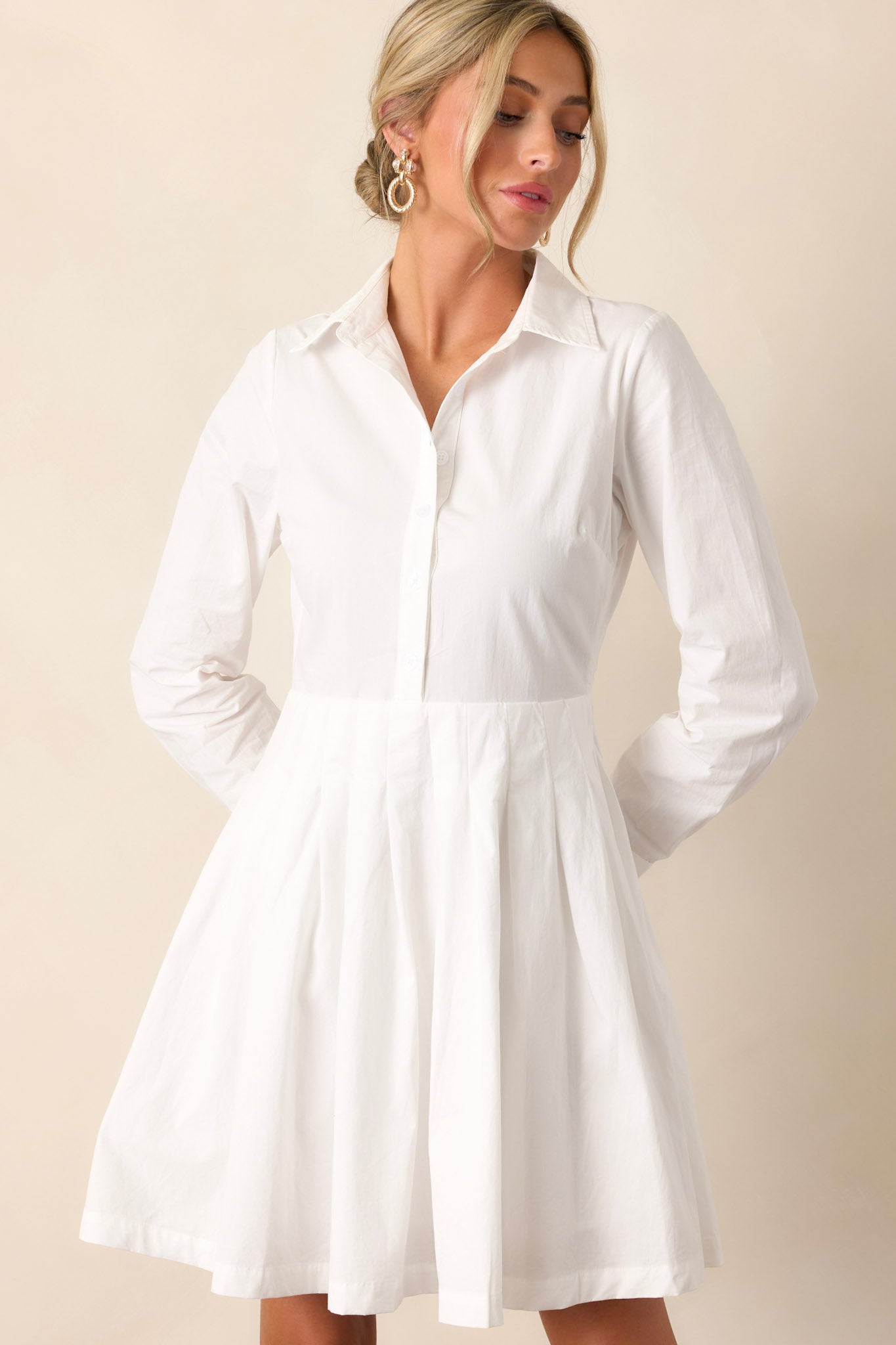 Front angled view of the versatile dress featuring a crisp white color and a mini length.