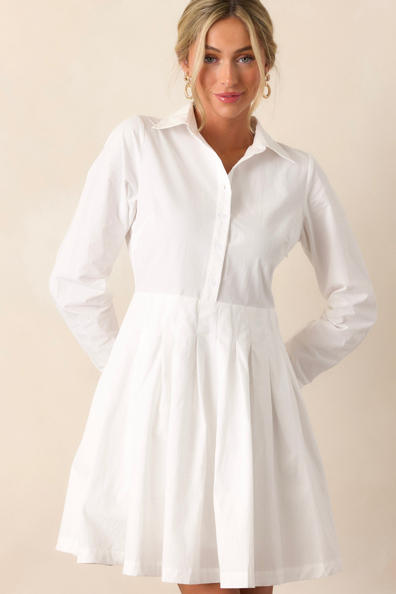 Front view of a versatile dress featuring a crisp white color and a mini length, designed for making a bold statement.