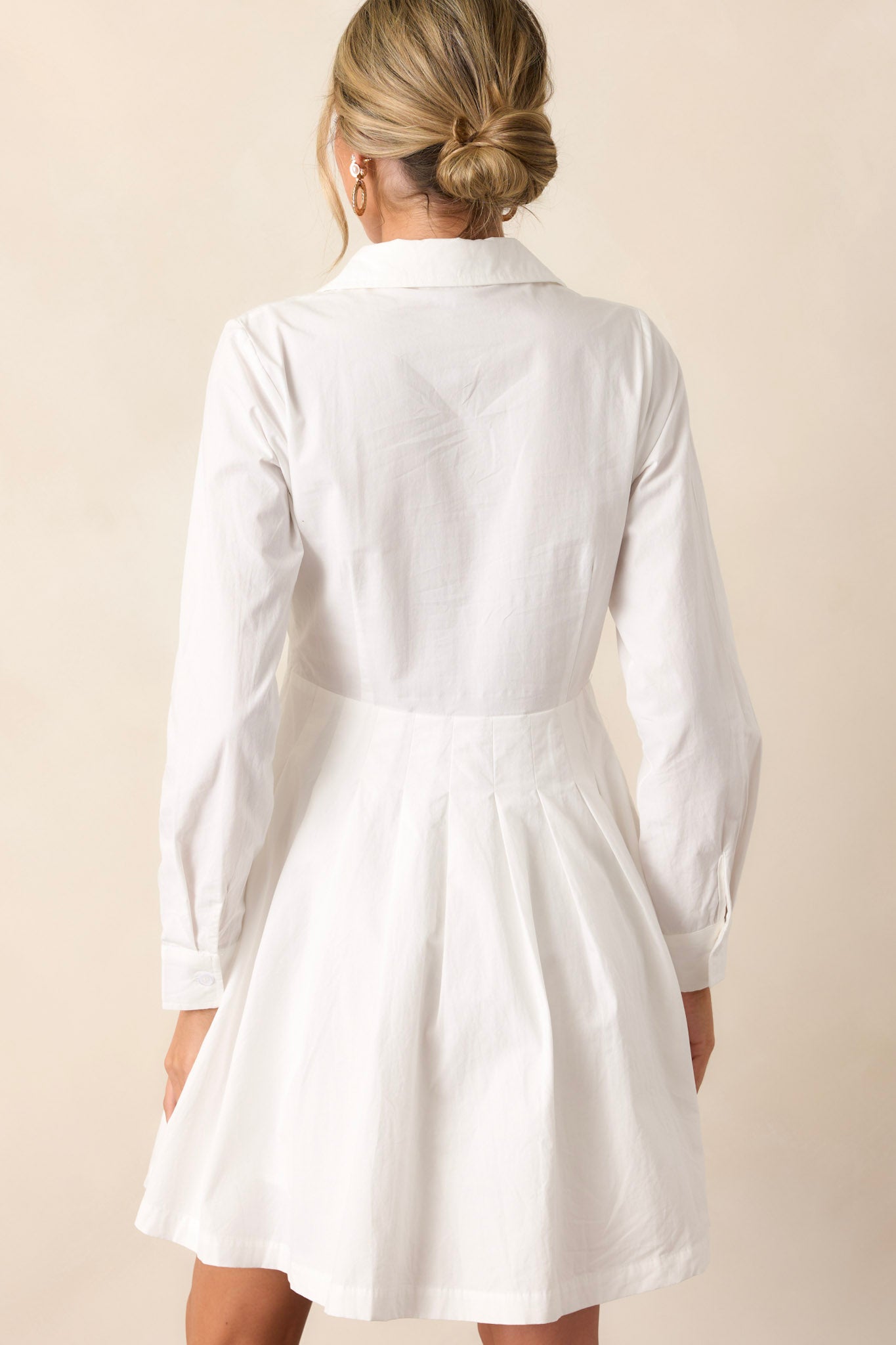 Back view of the versatile dress highlighting the clean, crisp white color and the sleek mini length.