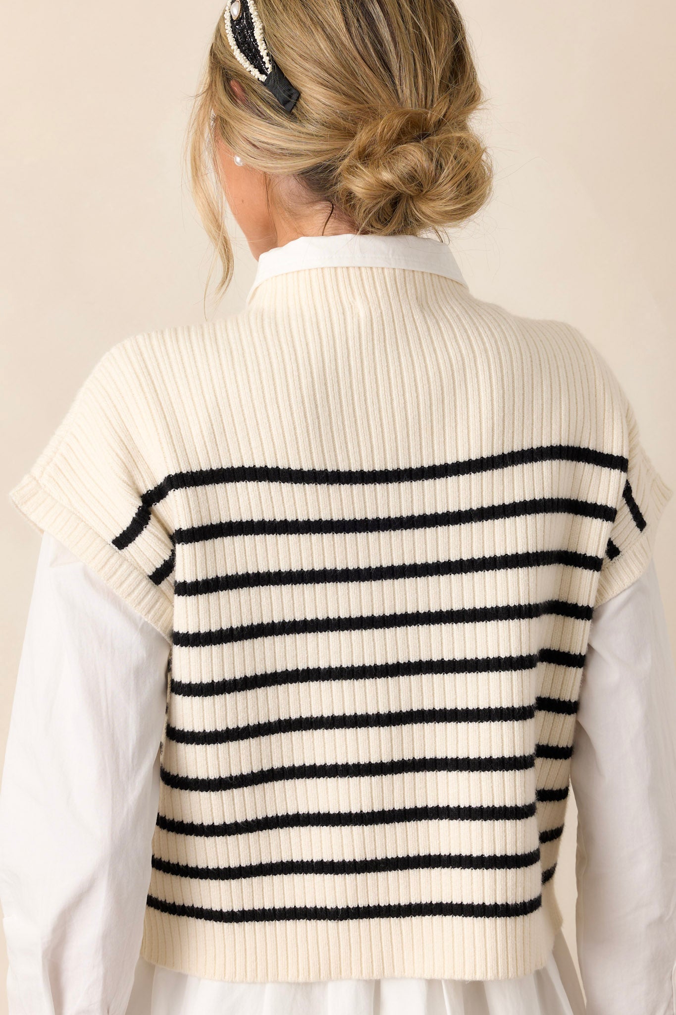 Back view of the ivory stripe top highlighting the black horizontal stripe pattern and the soft thick knit material.