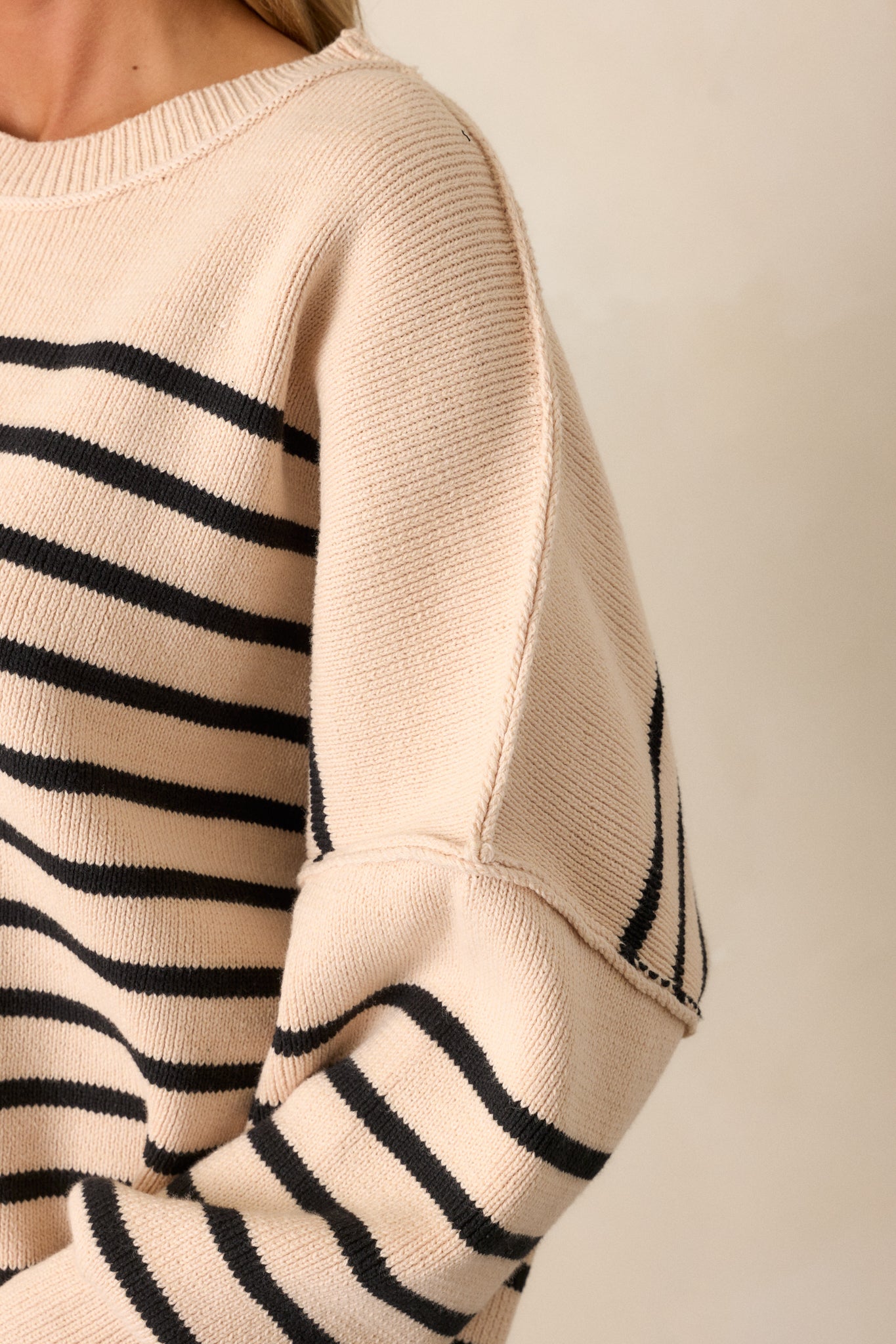 Close-up detail shot of the ribbed hem and side slit, with a clear view of the texture and stripe pattern.