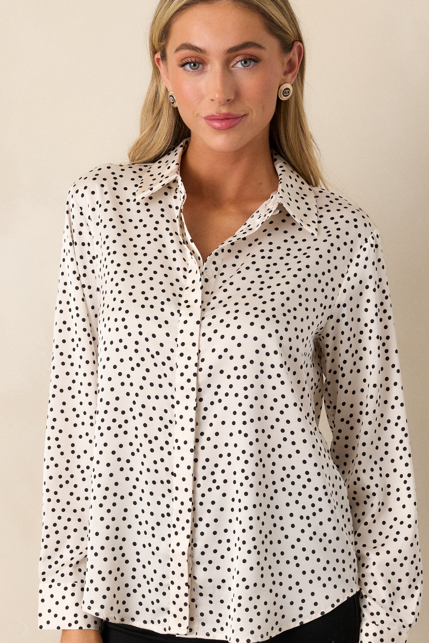 Cropped shot focusing on the button front of the polka dot top, highlighting the discreet design and fabric drape.