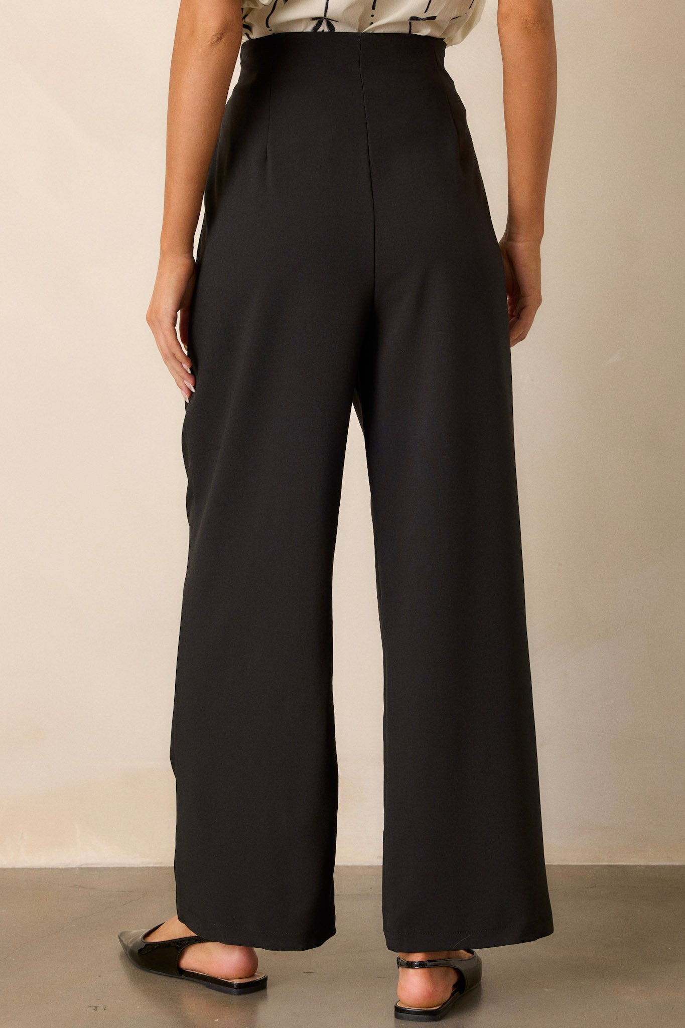 Back view of the black straight leg pants highlighting the clean lines of the high waist and the straight leg silhouette.