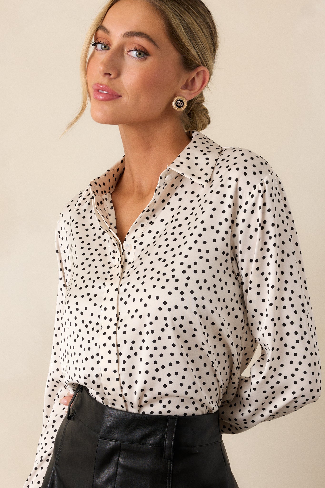 Cropped view highlighting the collared neckline and upper portion of the polka dot top, showcasing the pattern and fabric texture.